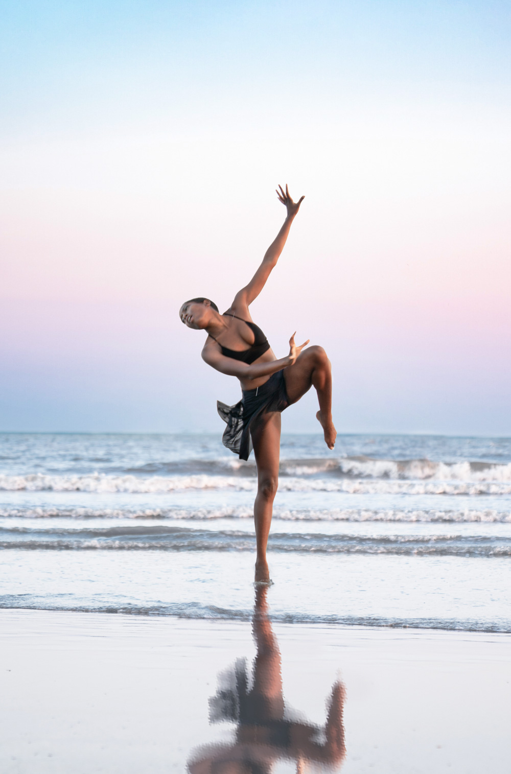 Dancer posing on the beach at sunset along Louisiana Gulf Coast