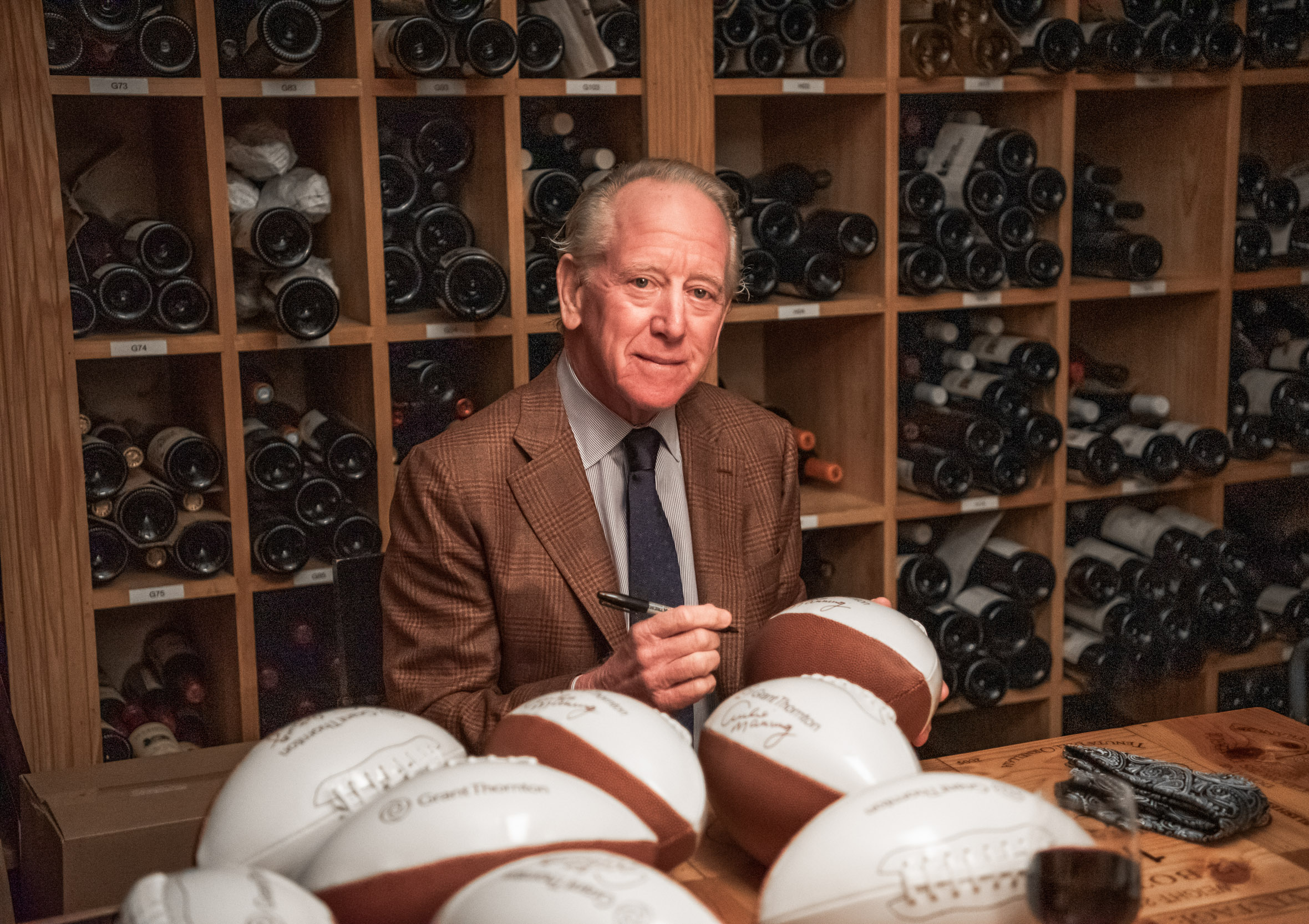 Archie Manning signing footballs at Commander’s Palace in New Orleans