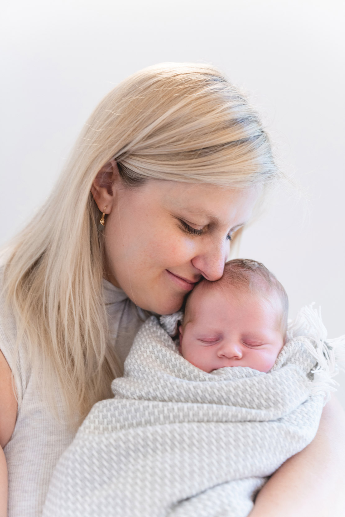 Beautiful mother holding baby while baby sleeps