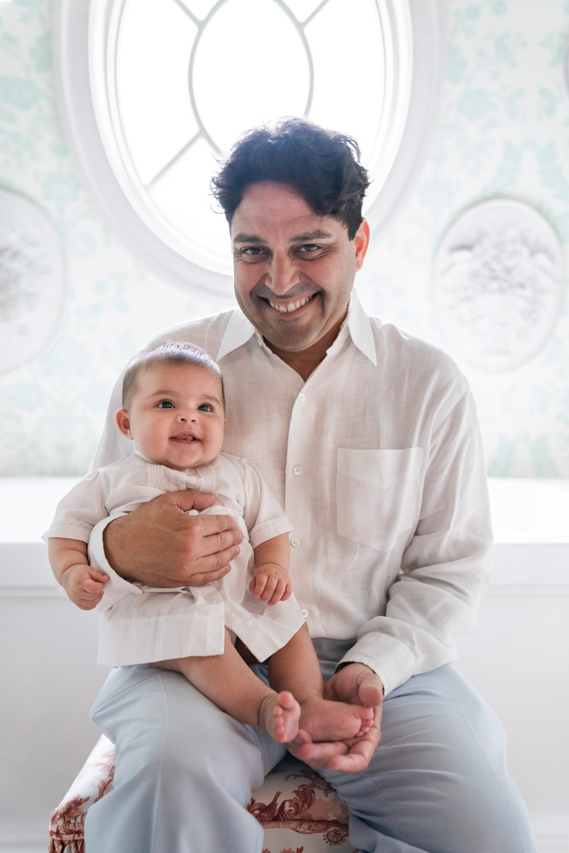 Happy father and baby smiling in a room with great lighting