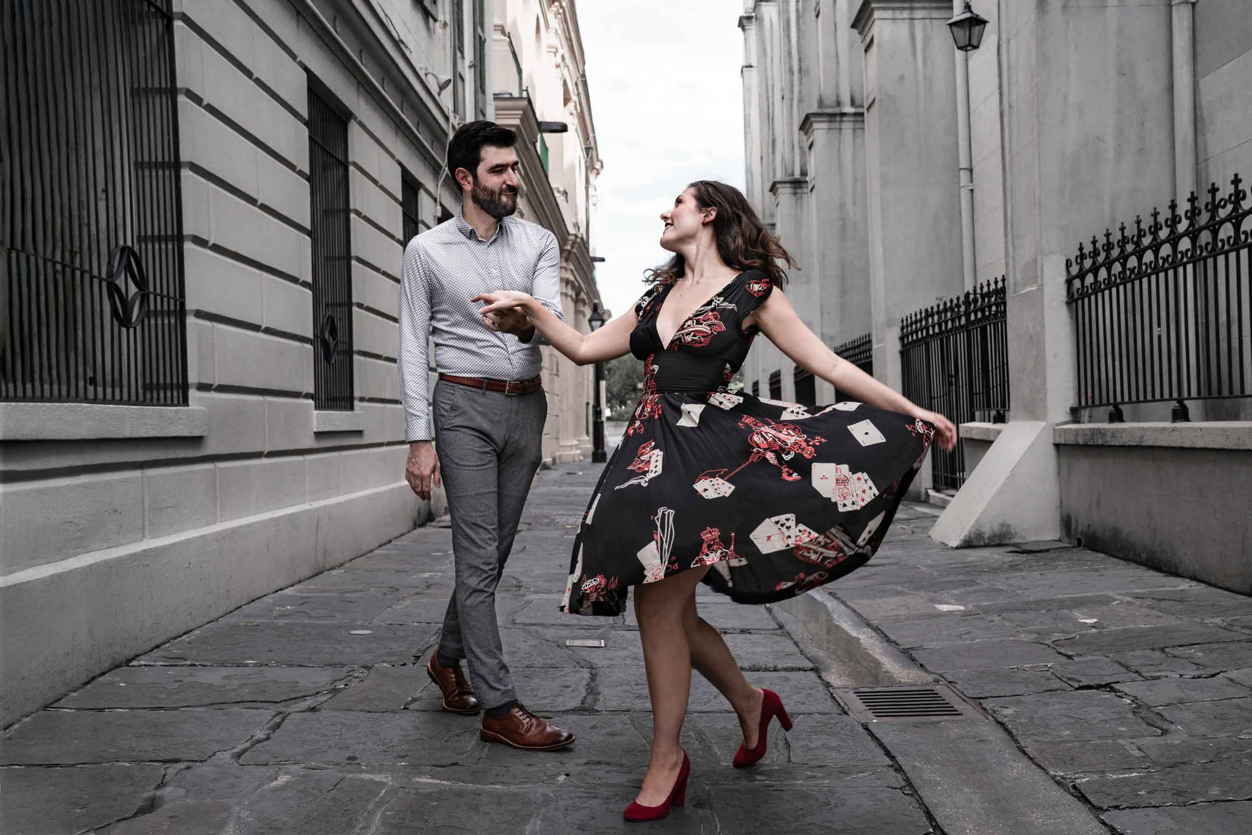 Romantic couple dancing in a French Quarter alley in New Orleans wearing great outfits