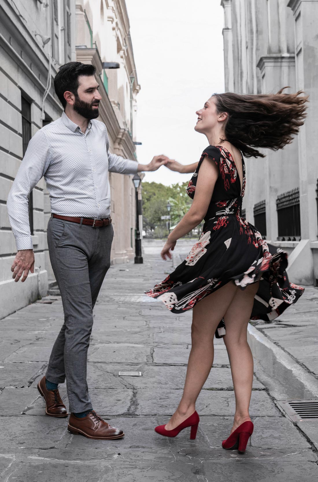 Romantic couple dancing together in an alleyway in front of a New Orleans French Quarter cathedral