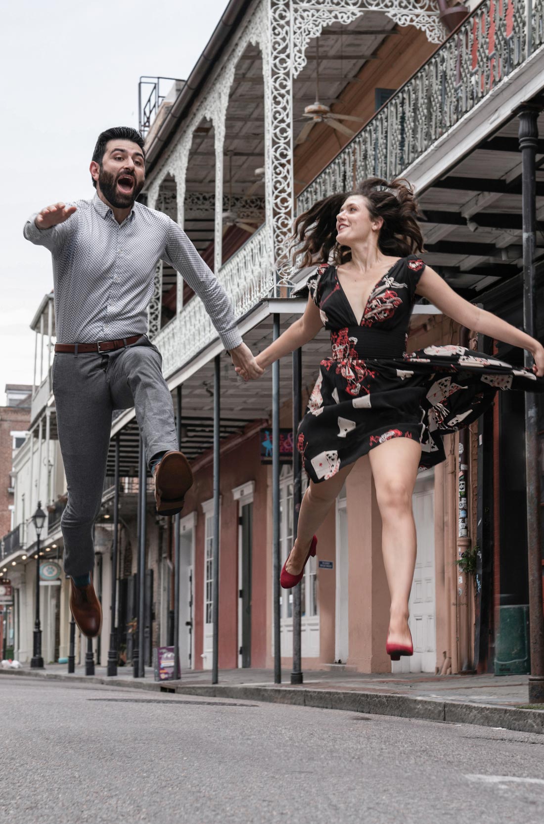 Romantic couple jumping with excitement in the New Orleans French Quarter