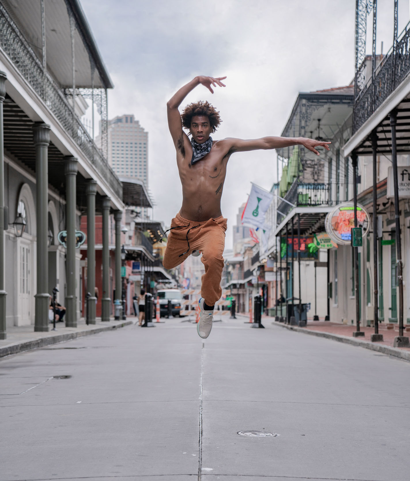 Shirtless dancer performing on Bourbon Street New Orleans