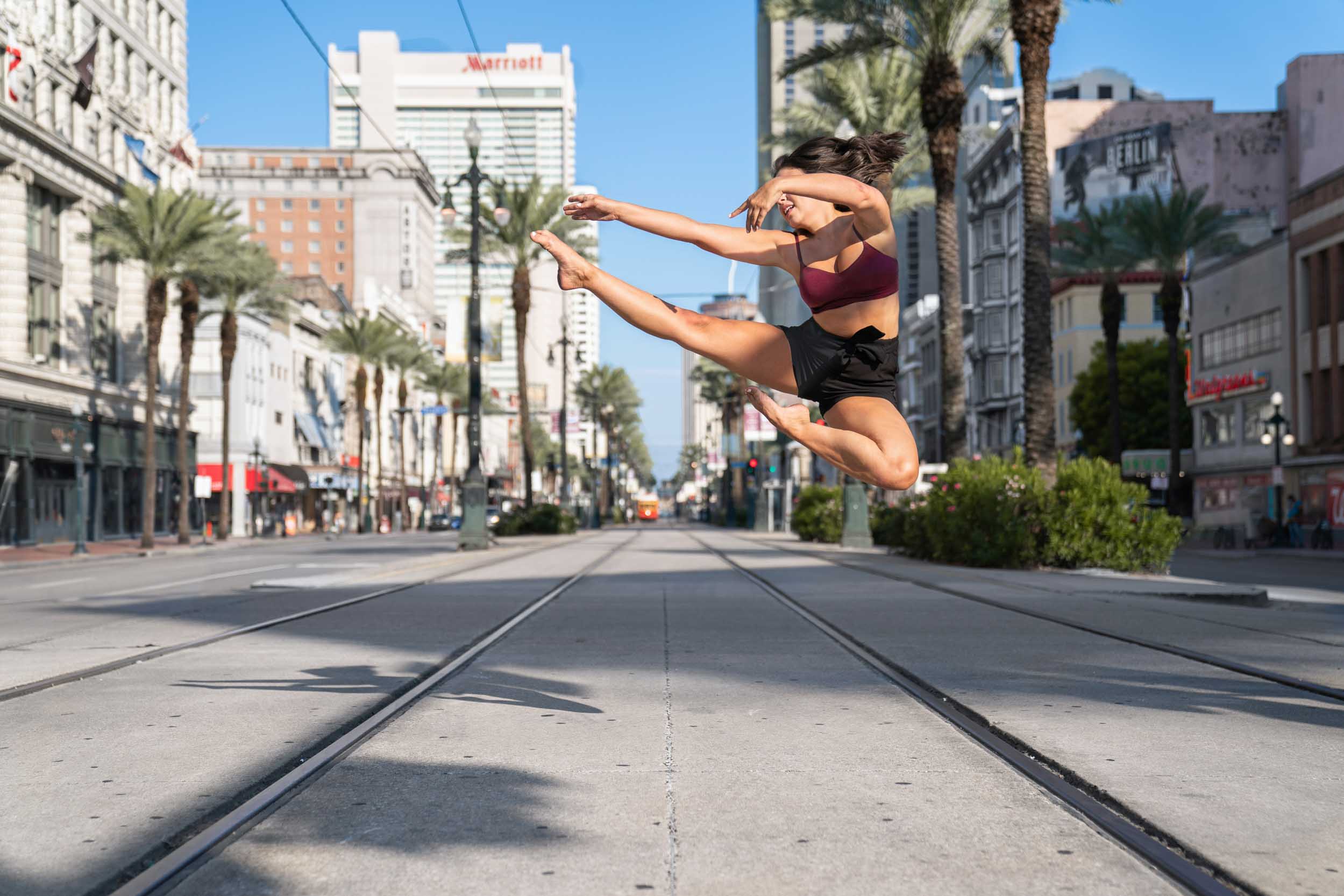 Dancer jumping in the air across Canal Street in New Orleans