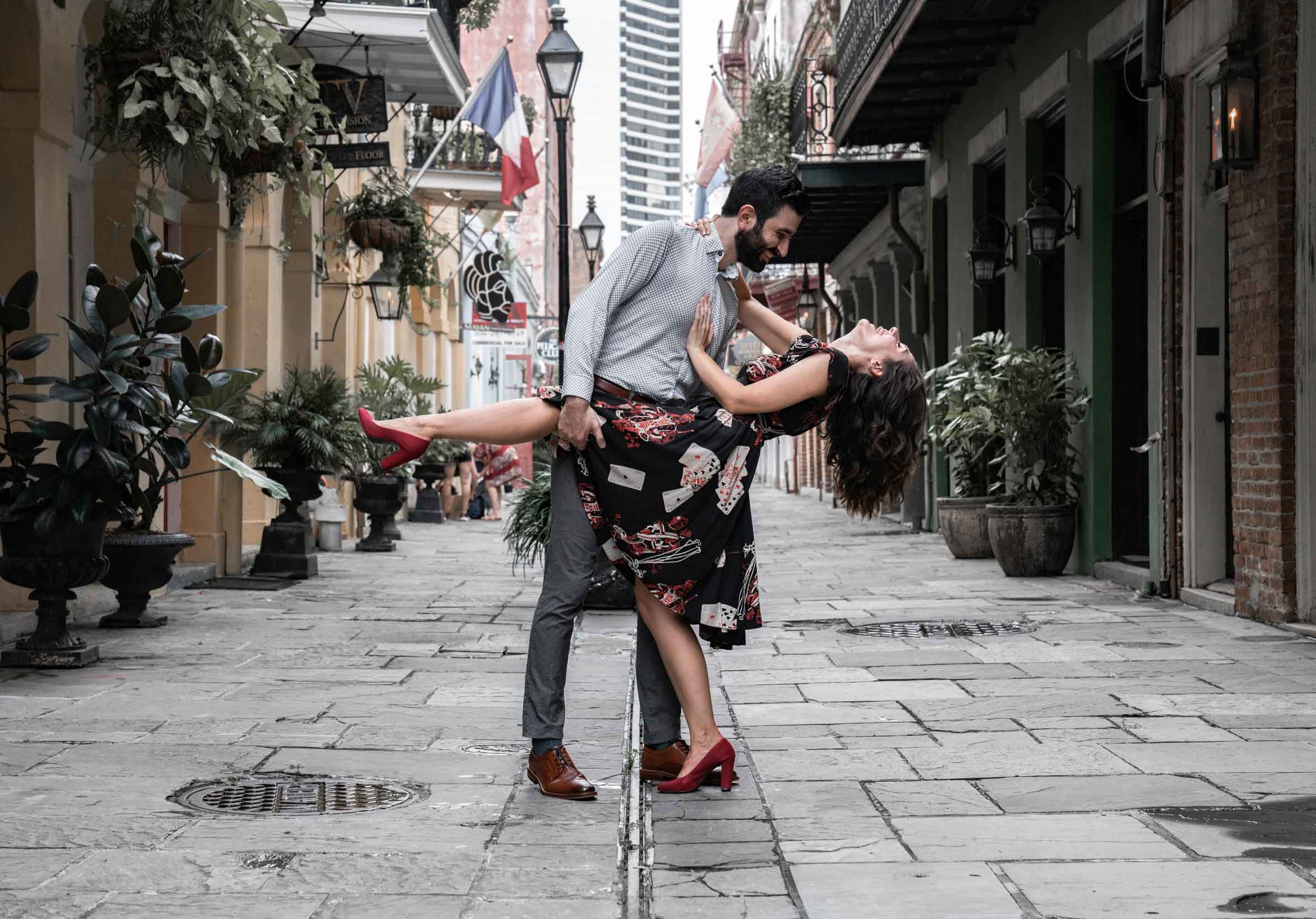 Romantic couple dancing in a French Quarter alley wearing great outfits