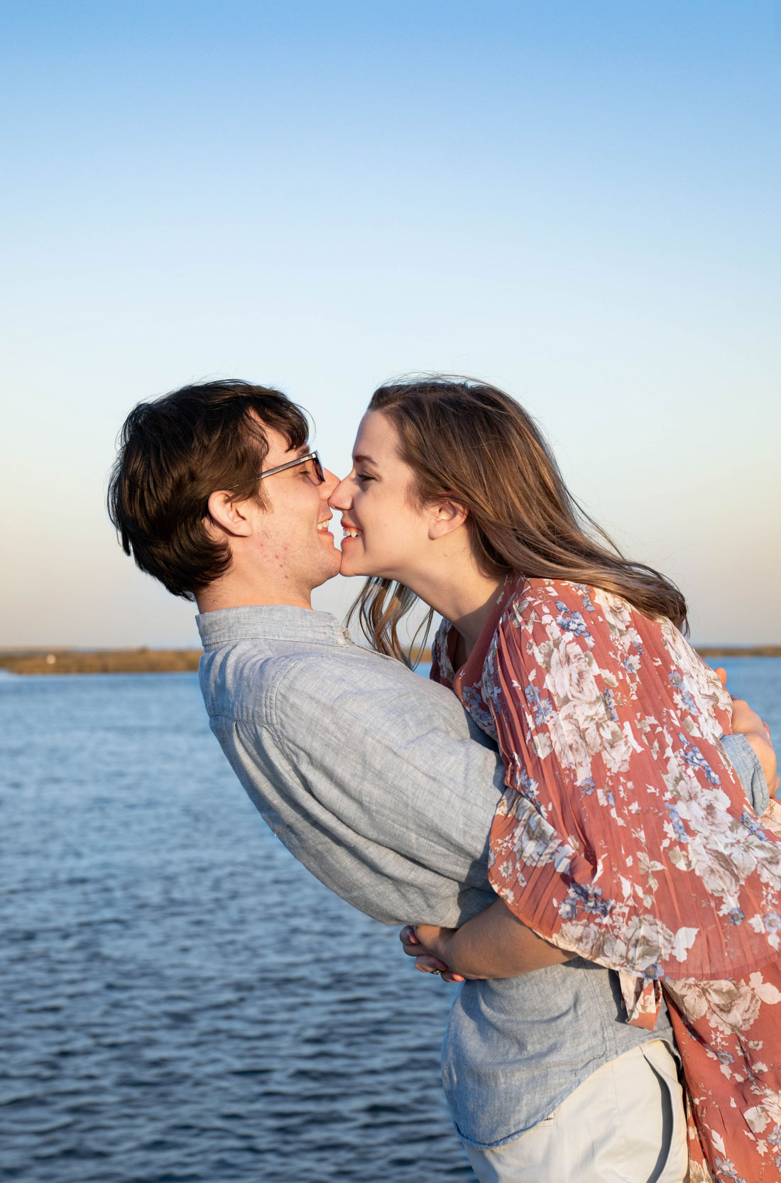 engagement-couple-laughing-in-love-proposal-sunset-water-vista-dock