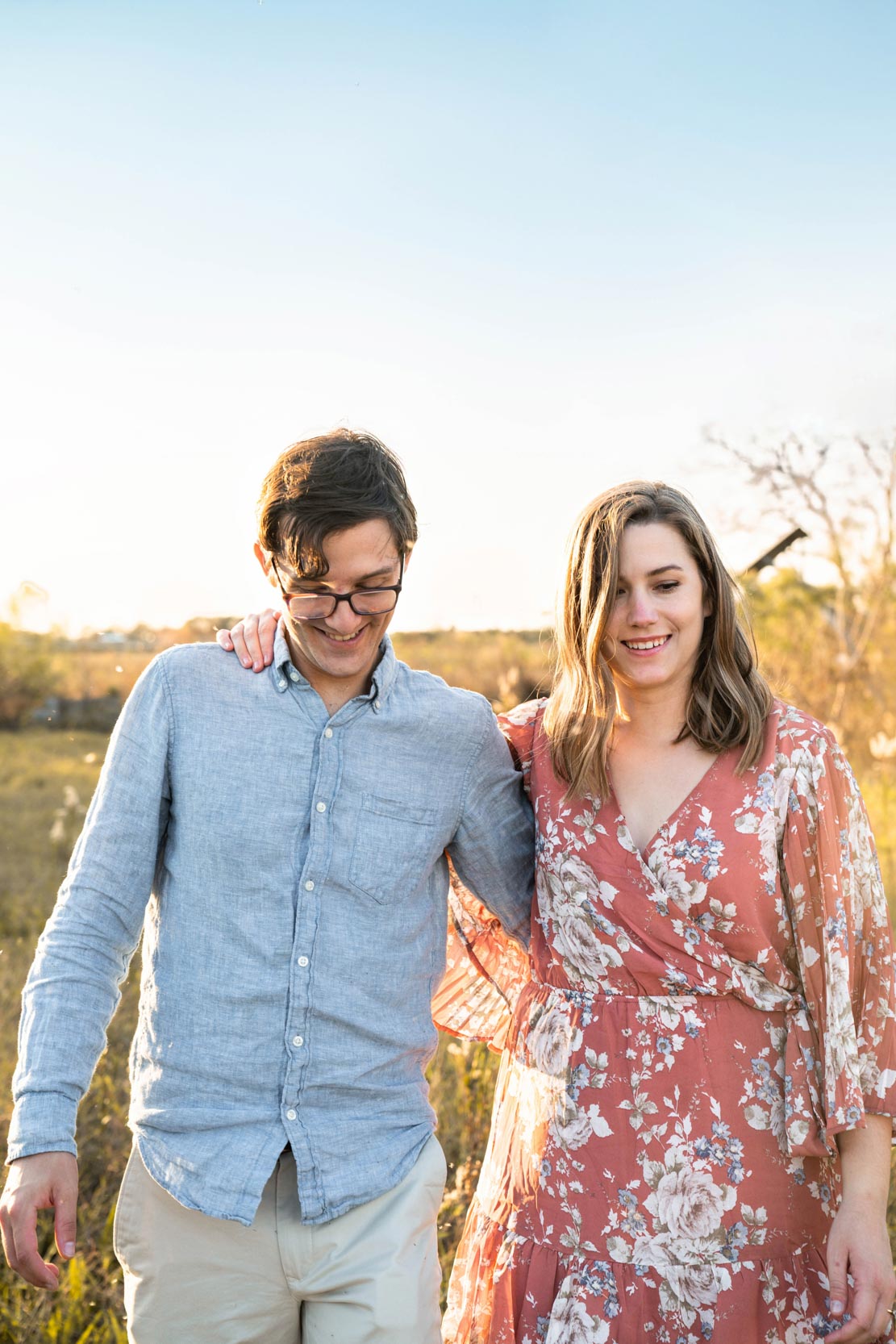 Happy couple walking together after proposal ceremony along a Louisiana bayou