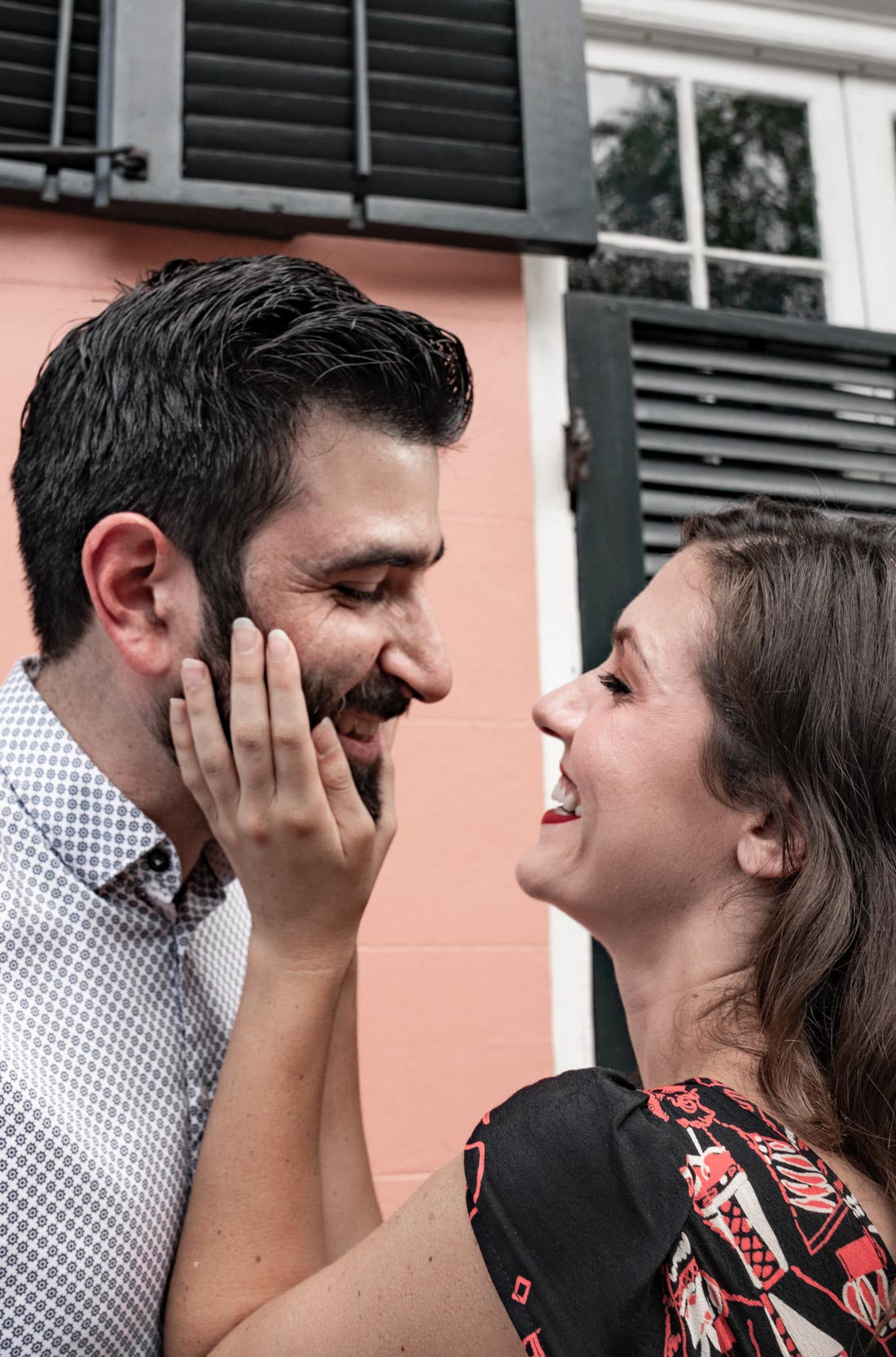 Woman playing with boyfriend’s beard and laughing in the New Orleans French Quarter