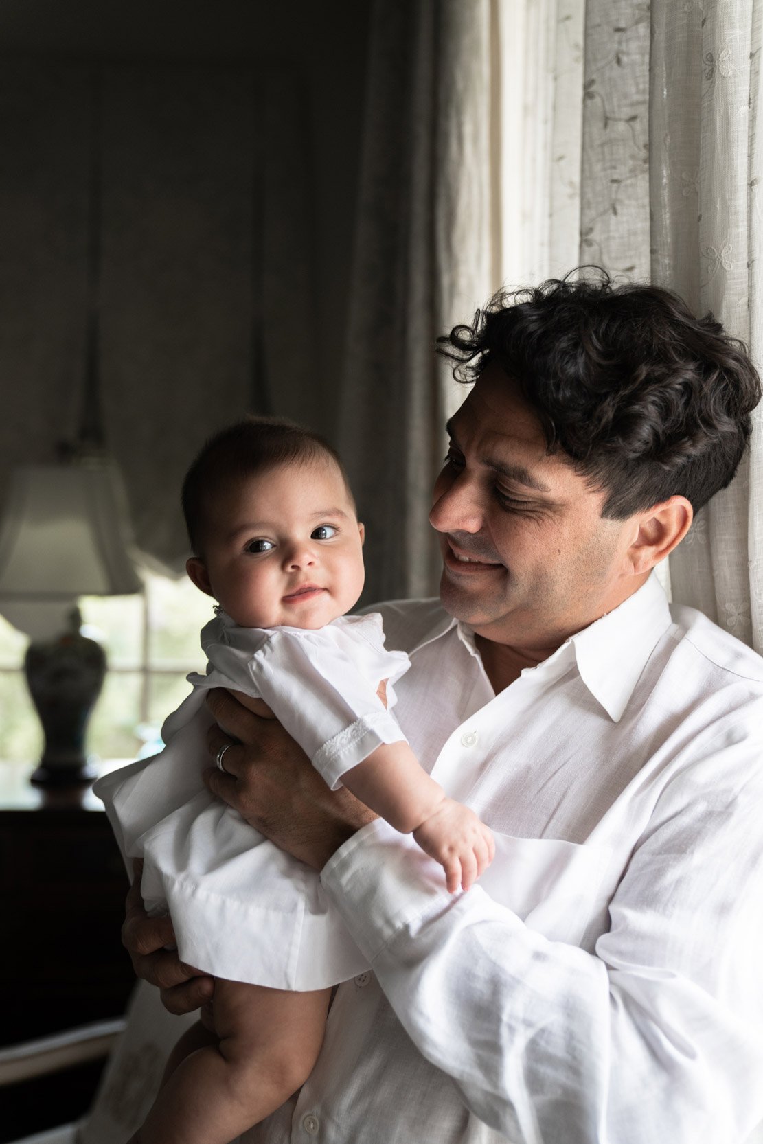 Father holding baby smiling