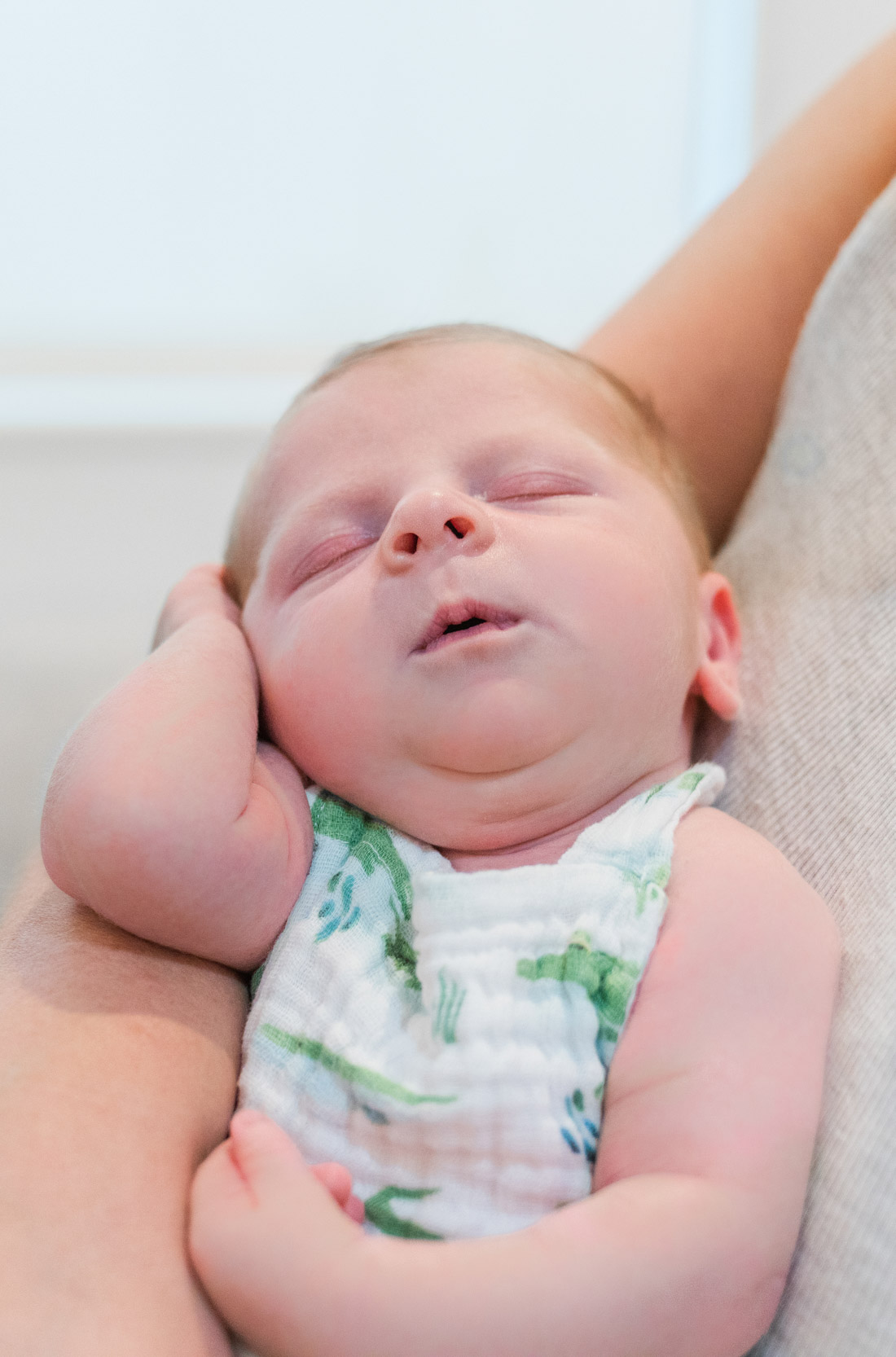 Mother holding baby while baby sleeps