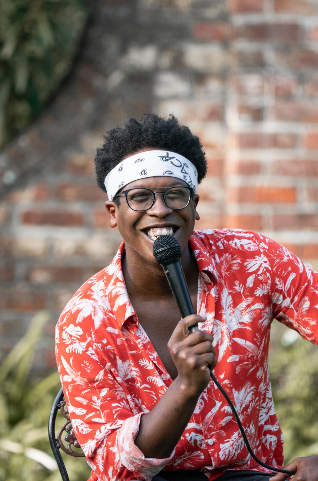 Musician singing and smiling during a performance in New Orleans