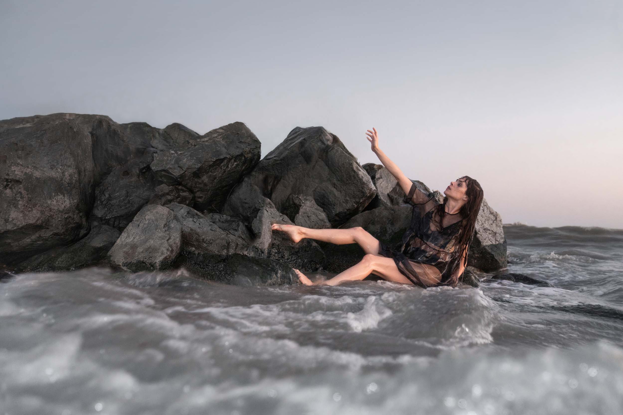 Woman reaching hand to the sky during a storm along the Louisiana Gulf Coast