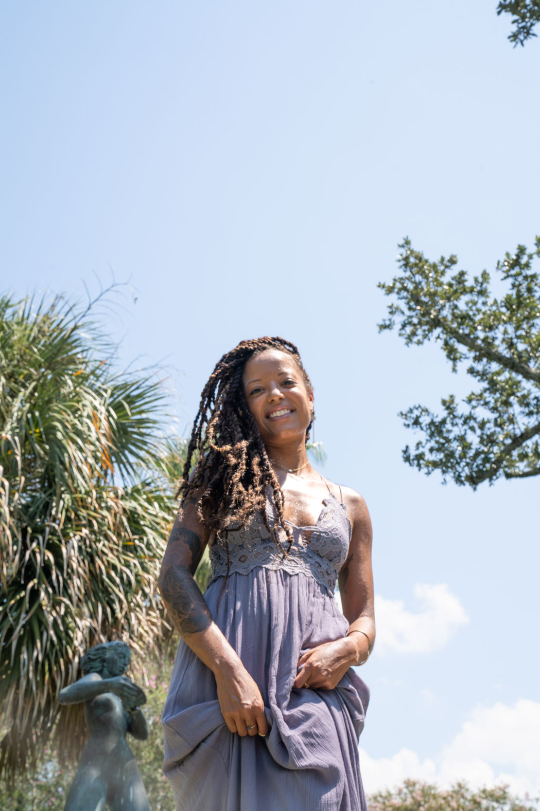 Woman smiling on sunny day in New Orleans City Park Botanical Garden