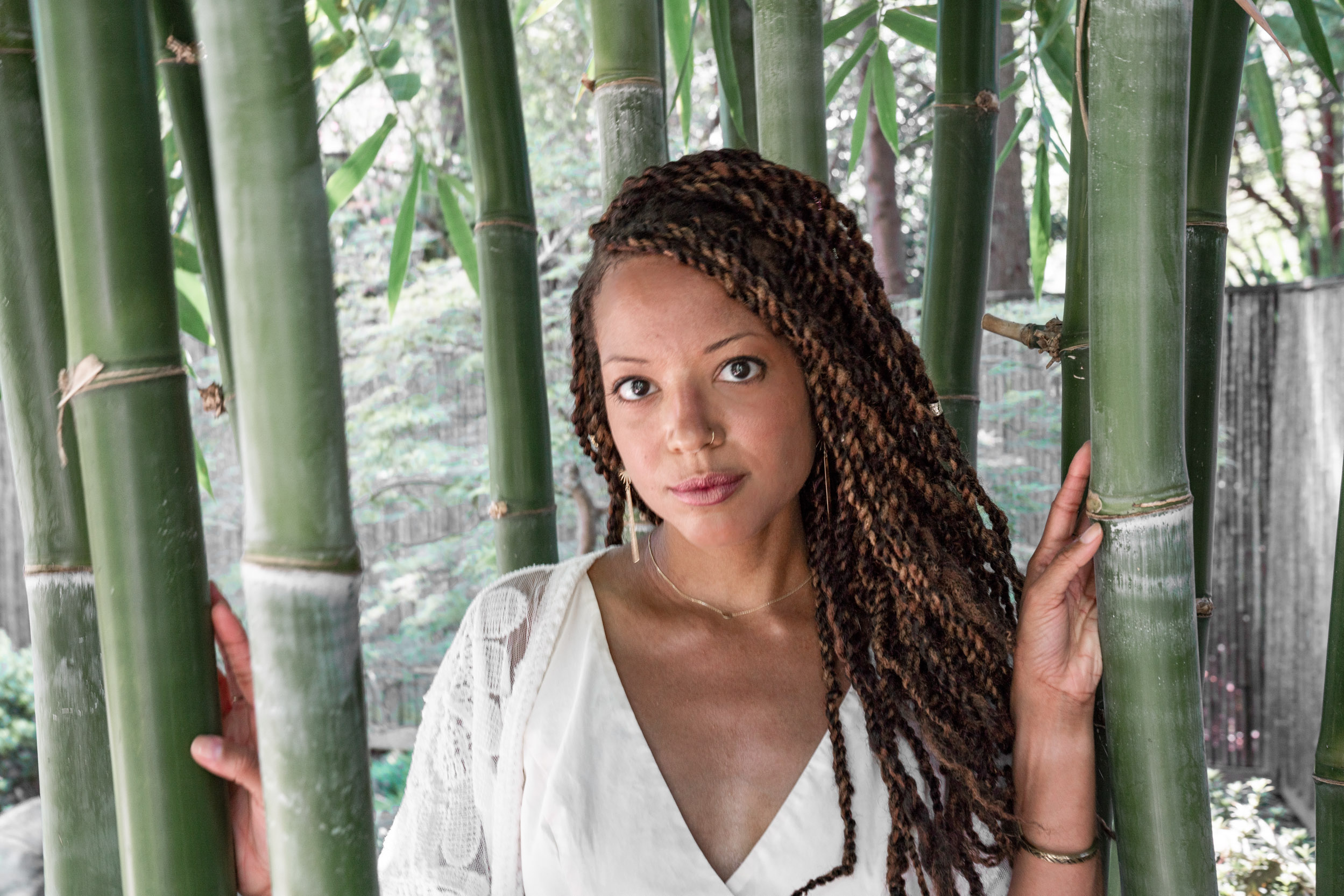 a woman modeling in a garden of bamboo trees in the New Orleans City Park Botanical Garden