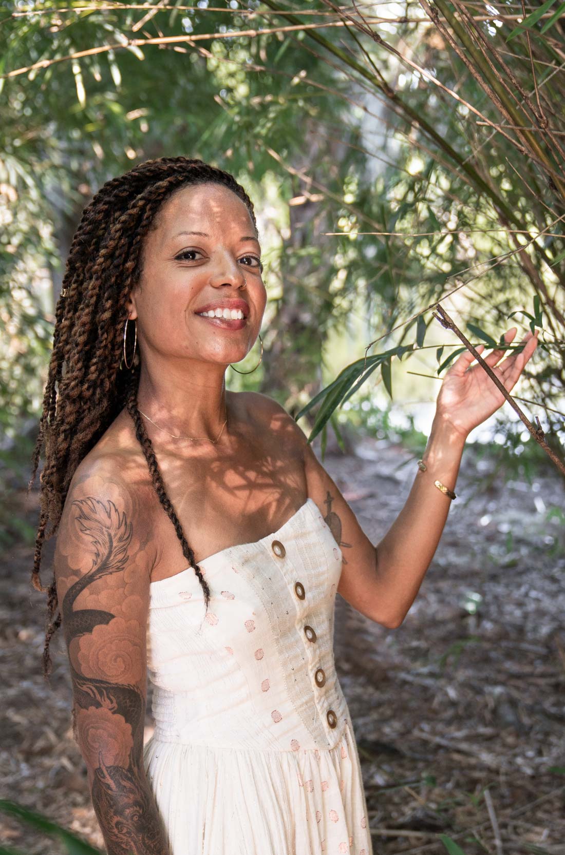 Woman smiling and touching plants in New Orleans City Park