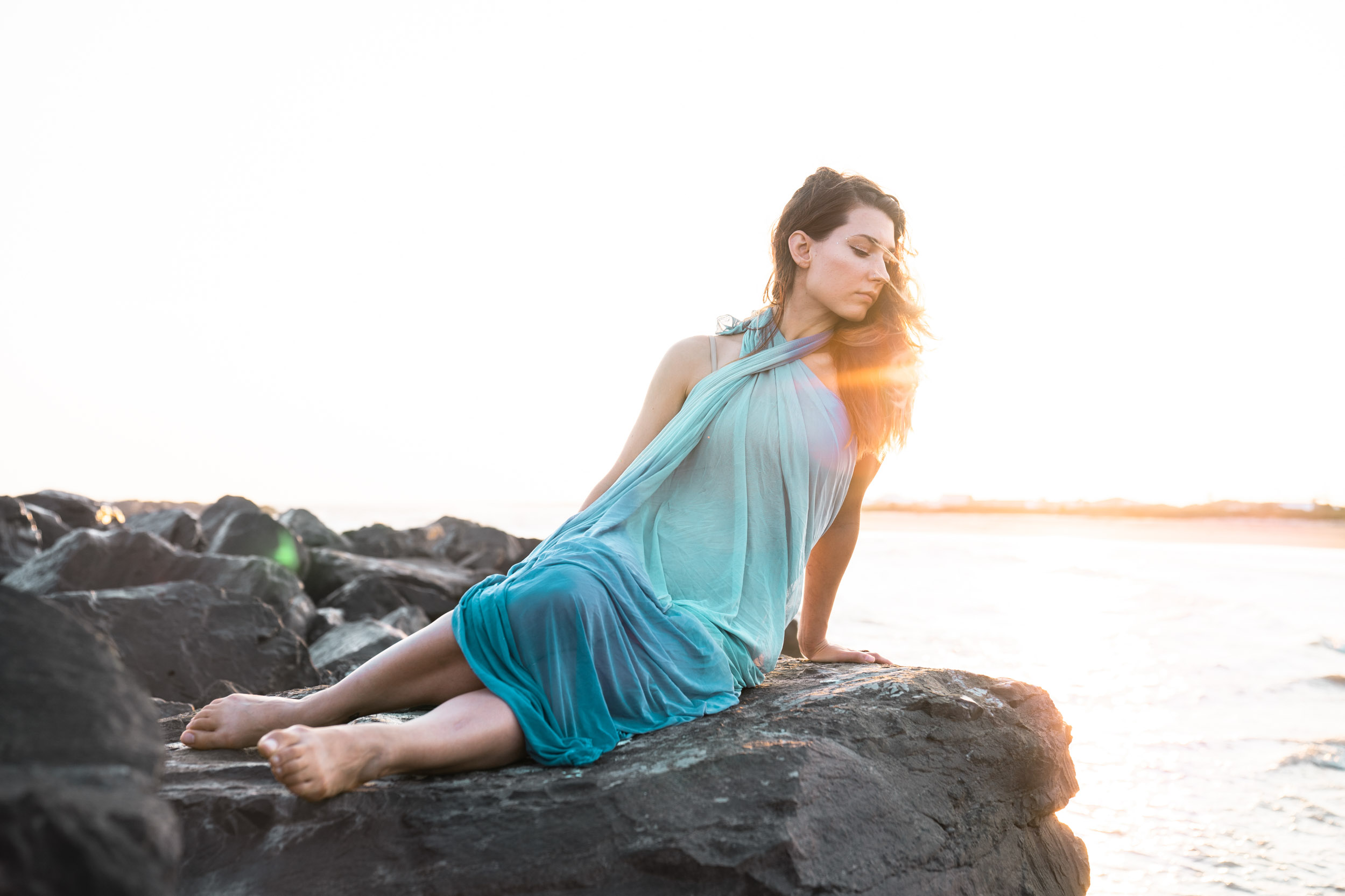 A woman modeling in a beautiful dress on a Louisiana Gulf Coast beach at sunset
