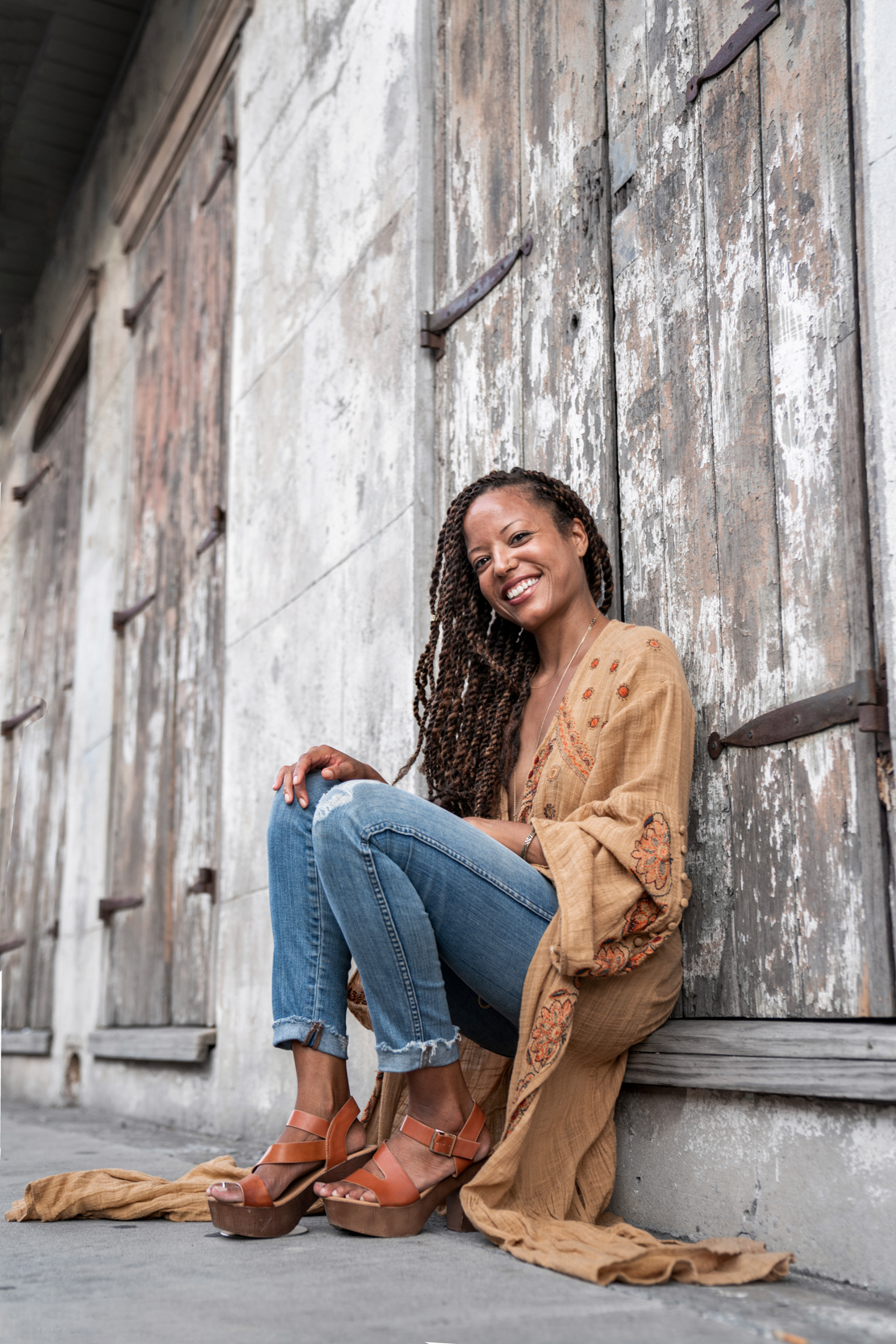 Woman modeling against rustic house in the New Orleans French Quarter