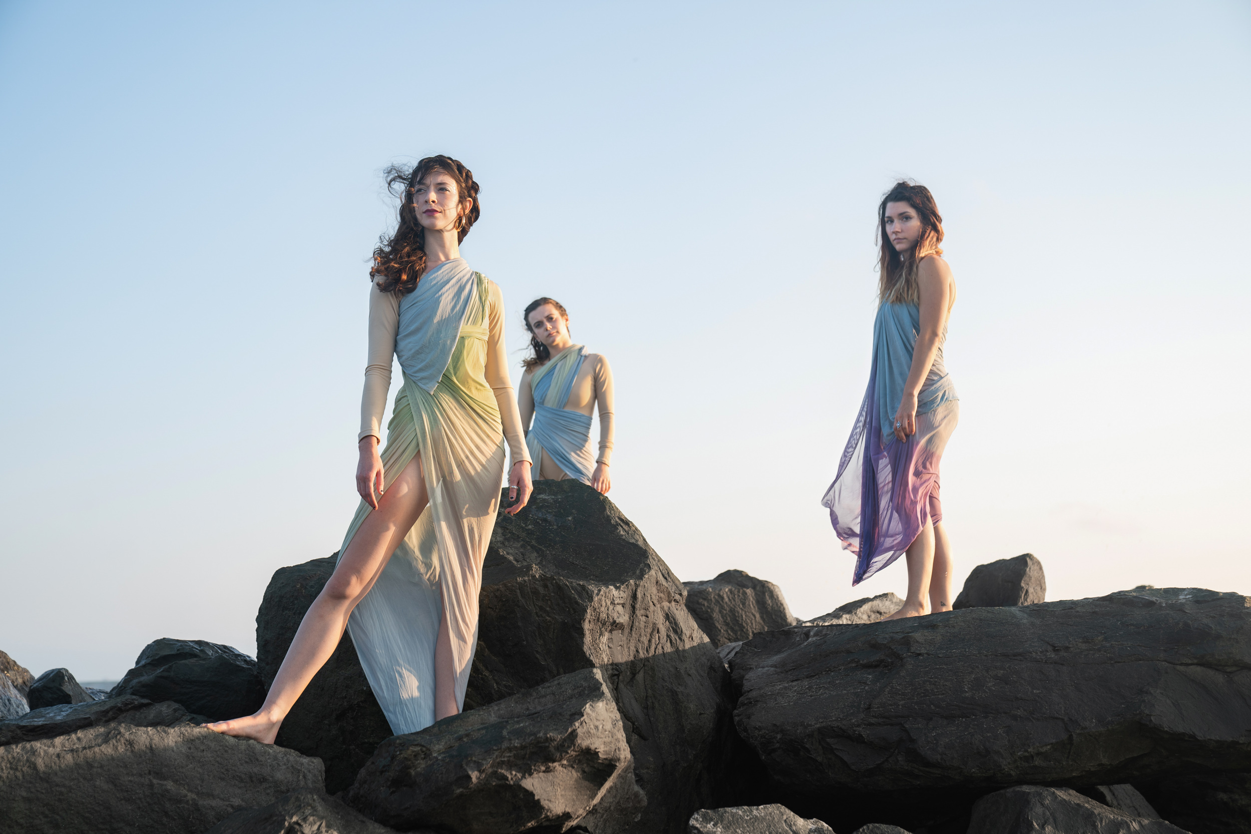Female dancers modeling and posing in pretty dresses on a Louisiana Gulf Coast beach at sunset