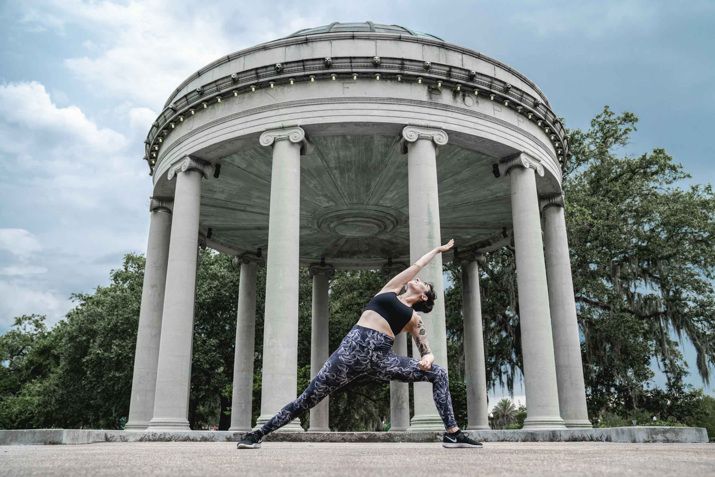 Yoga teacher performing in front of epic monument in New Olreans park