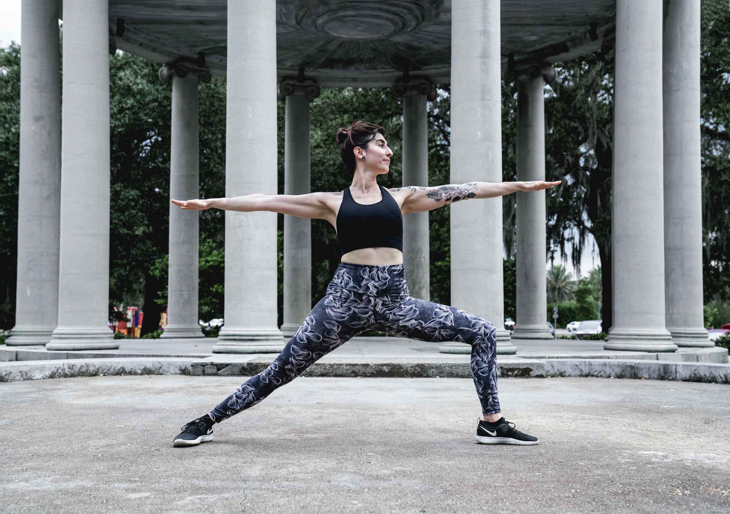 Yoga teacher posing in front of monument in New Orleans park