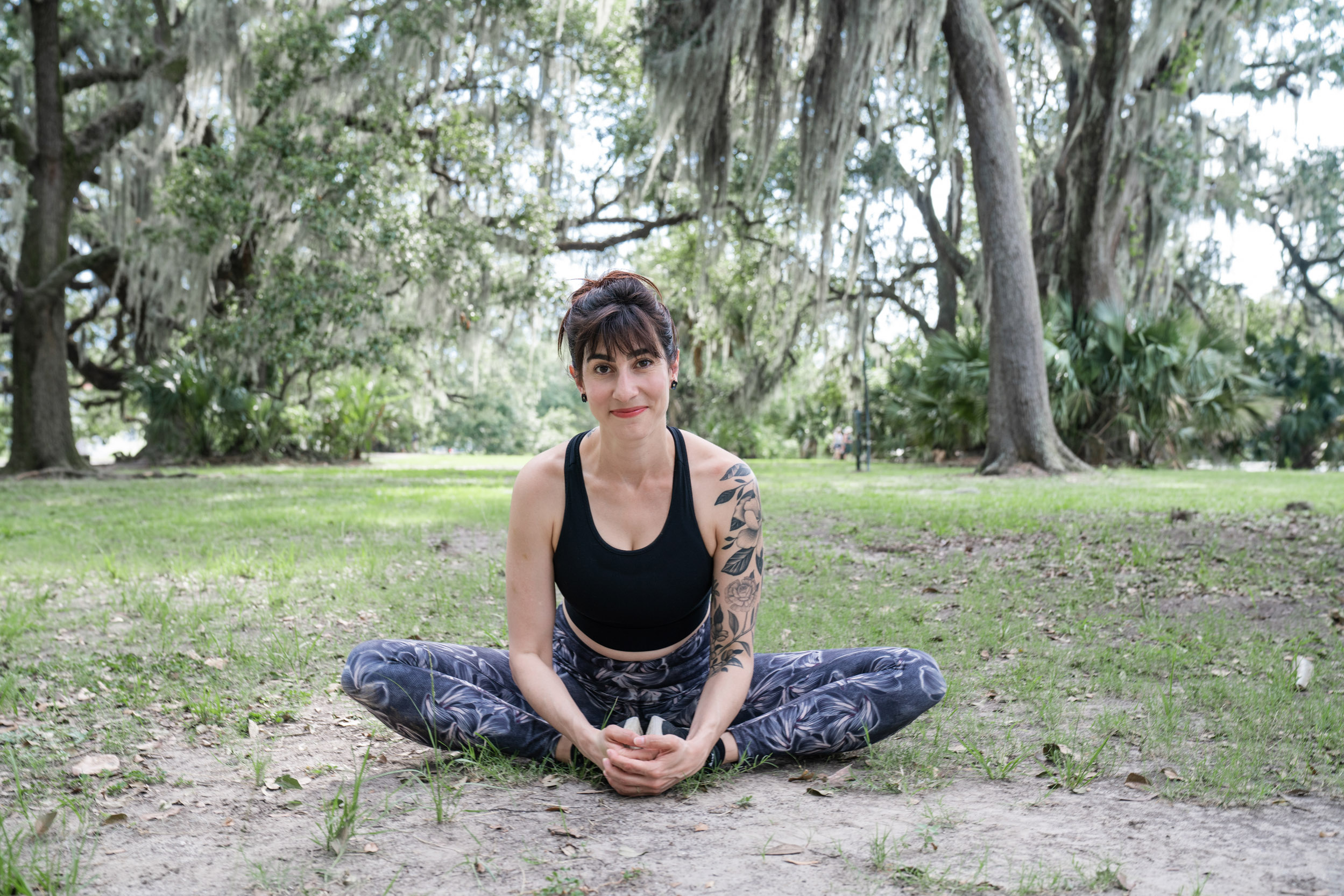 a yoga teacher posing and smiling in New Orleans City Park