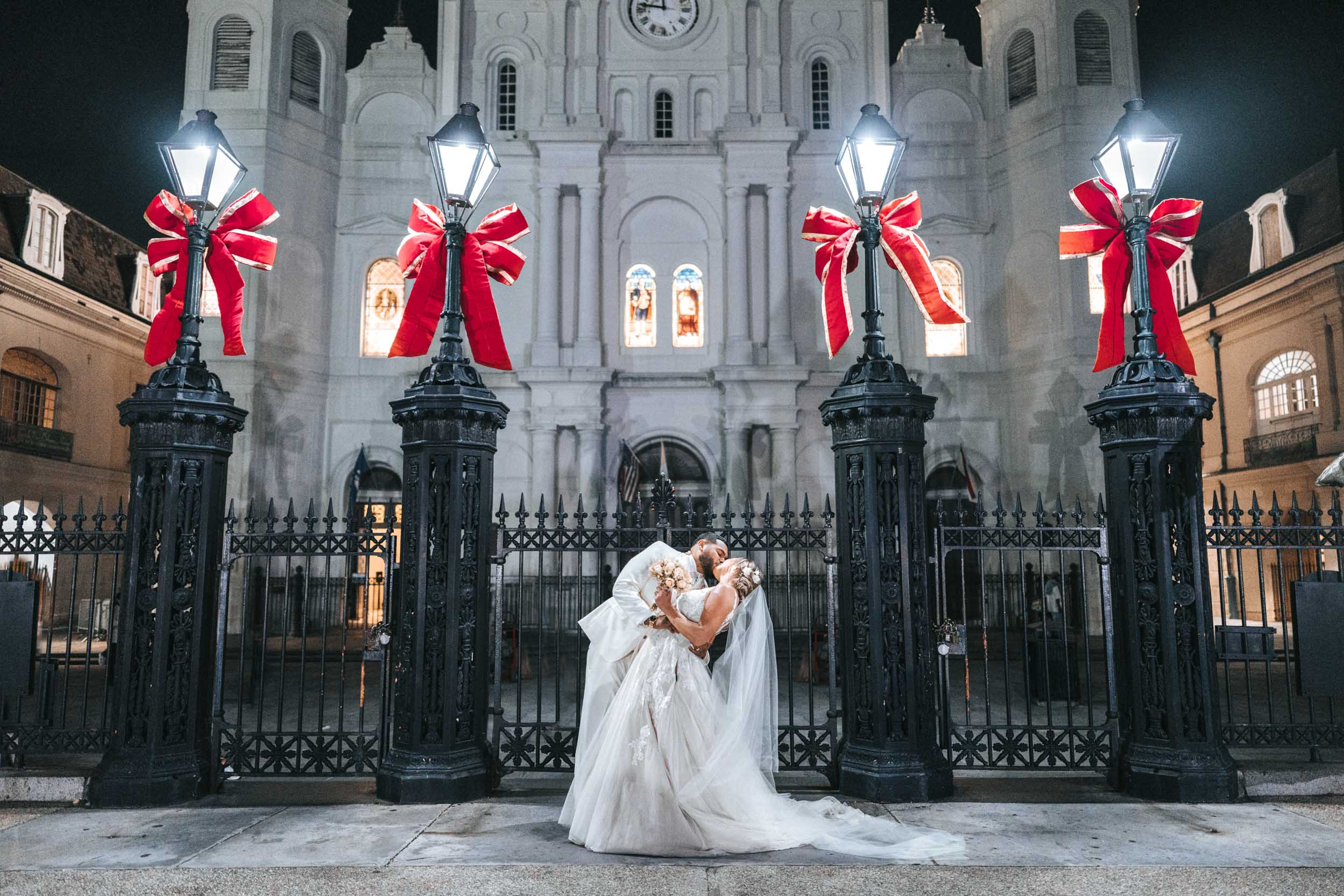 bride and groom kissing in front of St. Louis Cathedral in Jackson Square New Orleans