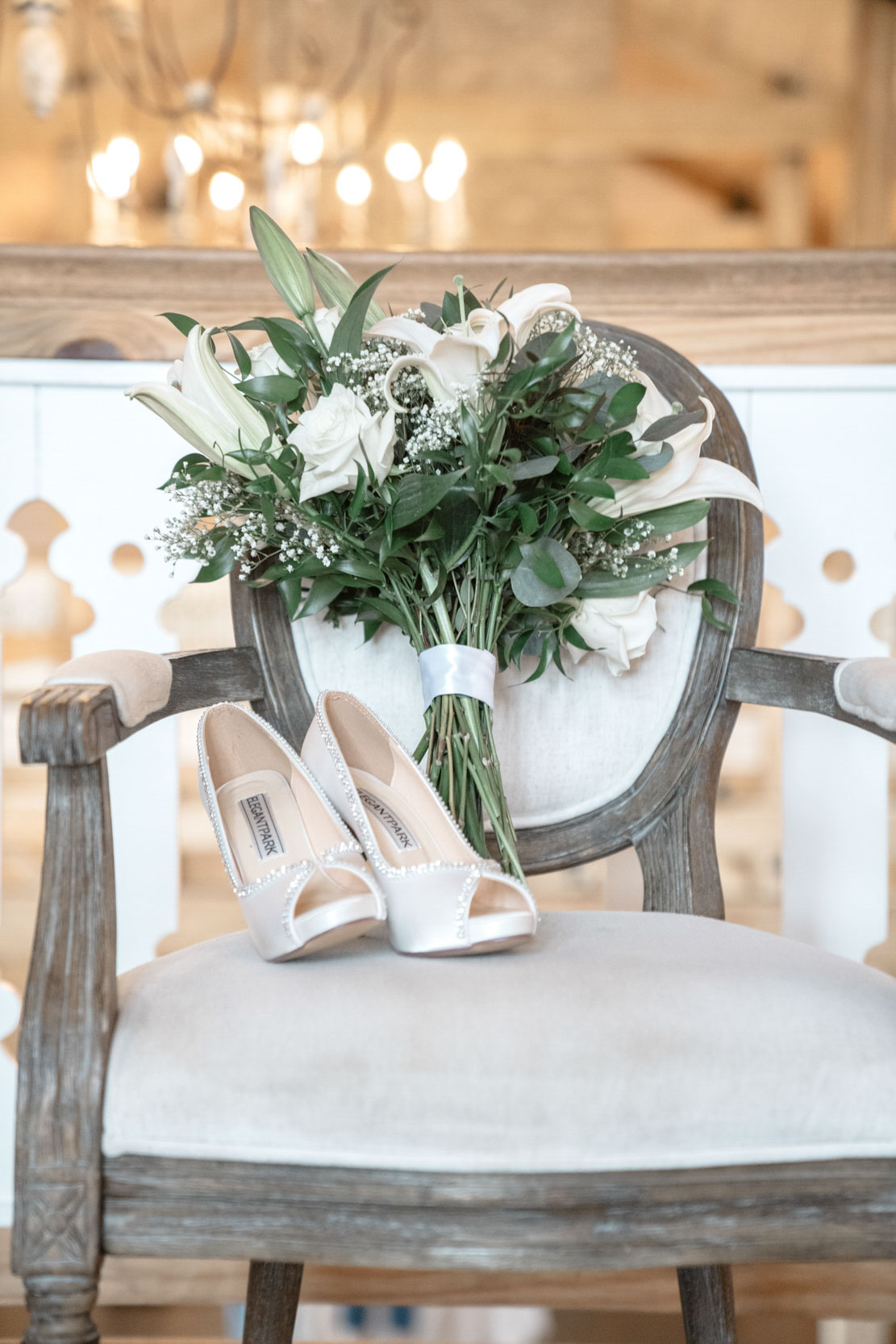 wedding flat lay of Elegant Park shoes and bridal flowers