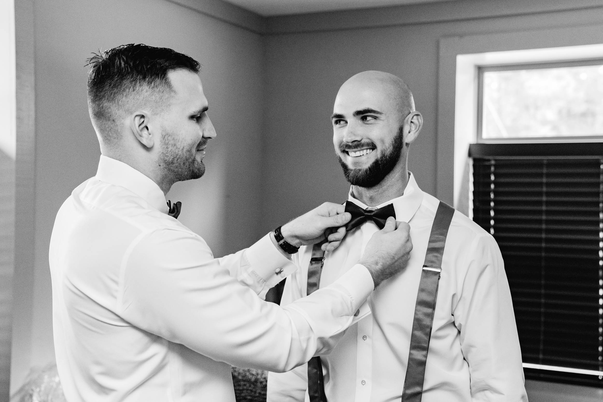 Groomsmen getting dressed at Creekview Barn in Mississippi