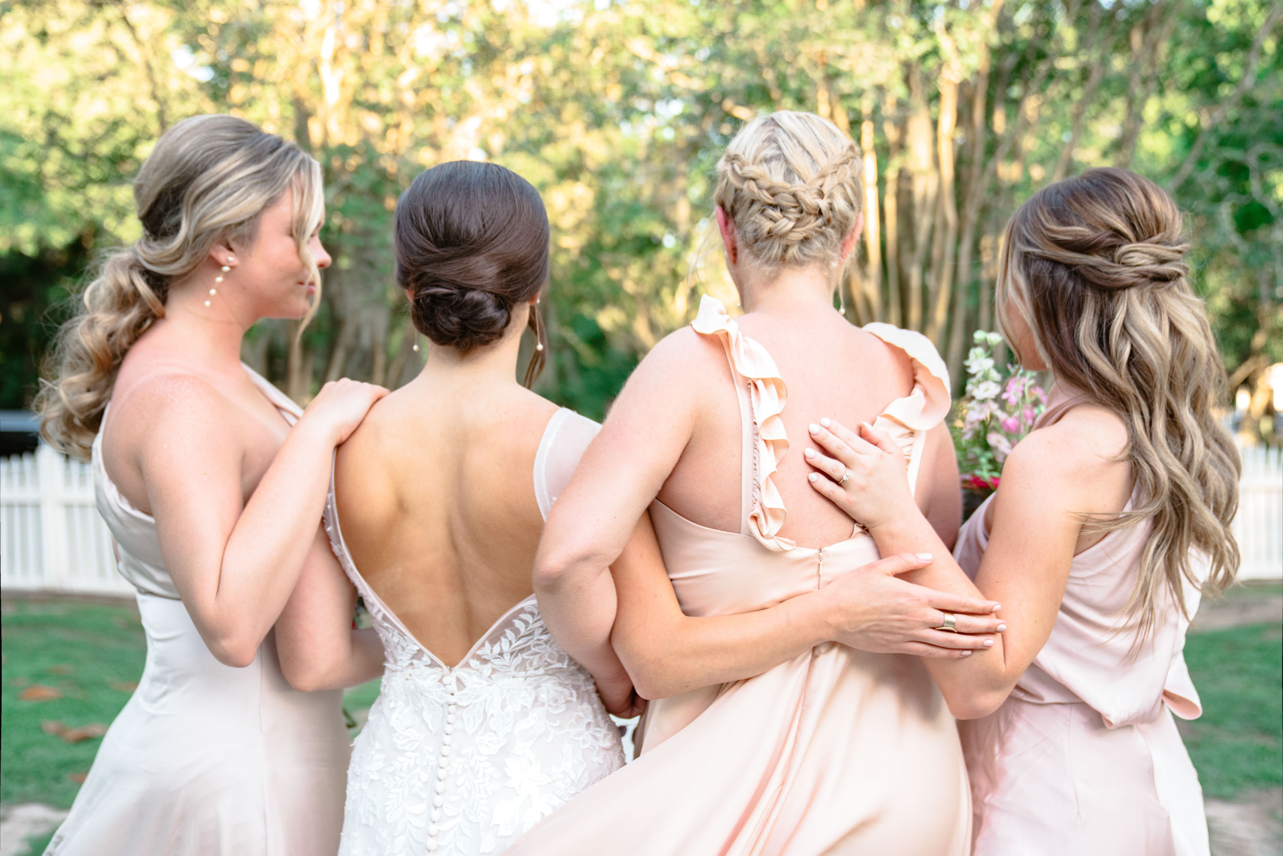 back of bride and bridesmaids' pink dresses at Maison Lafitte in Covington, Louisiana