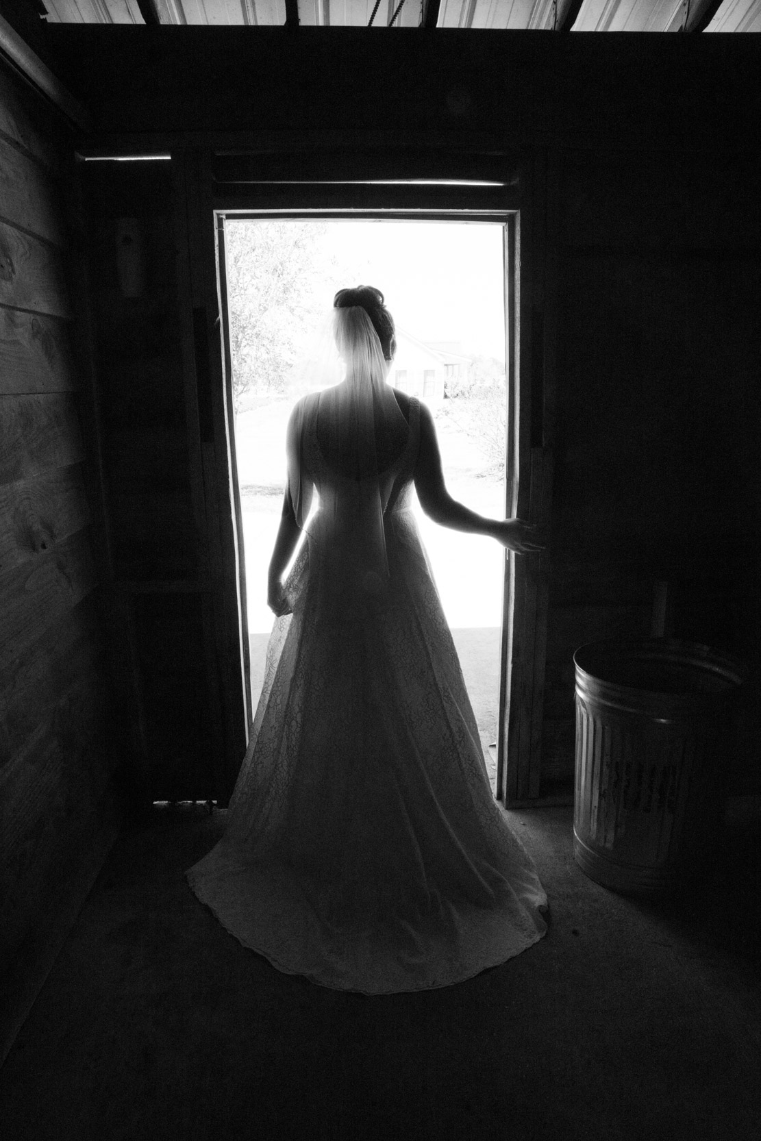 bride waiting in doorway for her first look with groom at Berry Barn in Louisiana
