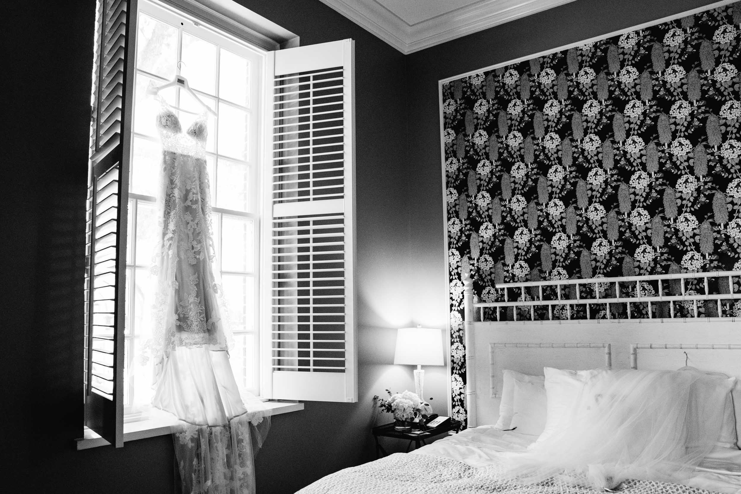 bridal gown hanging on window sill The Southern Hotel in Covington, Louisiana.jpg