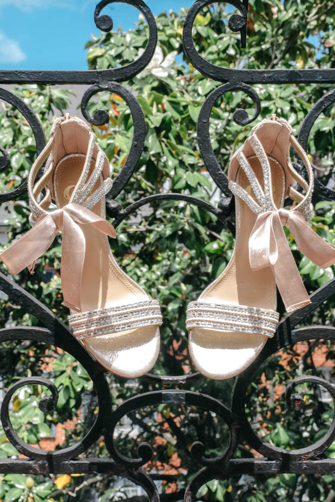 bridal shoes hanging from wrought iron balcony at Hotel Mazarin in The French Quarter of New Orleans