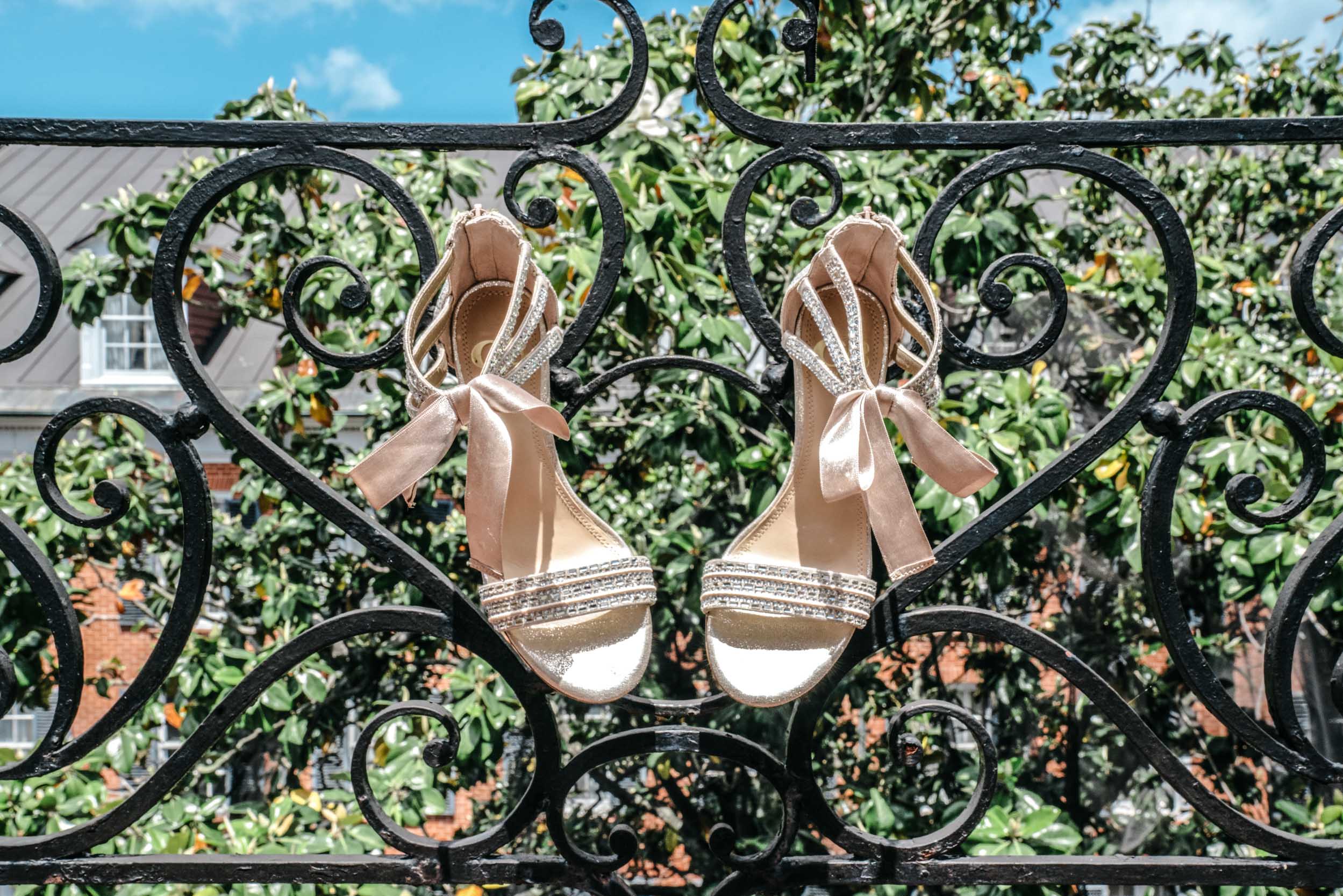 bridal shoes hanging from wrought iron balcony at Hotel Mazarin in The French Quarter of New Orleans