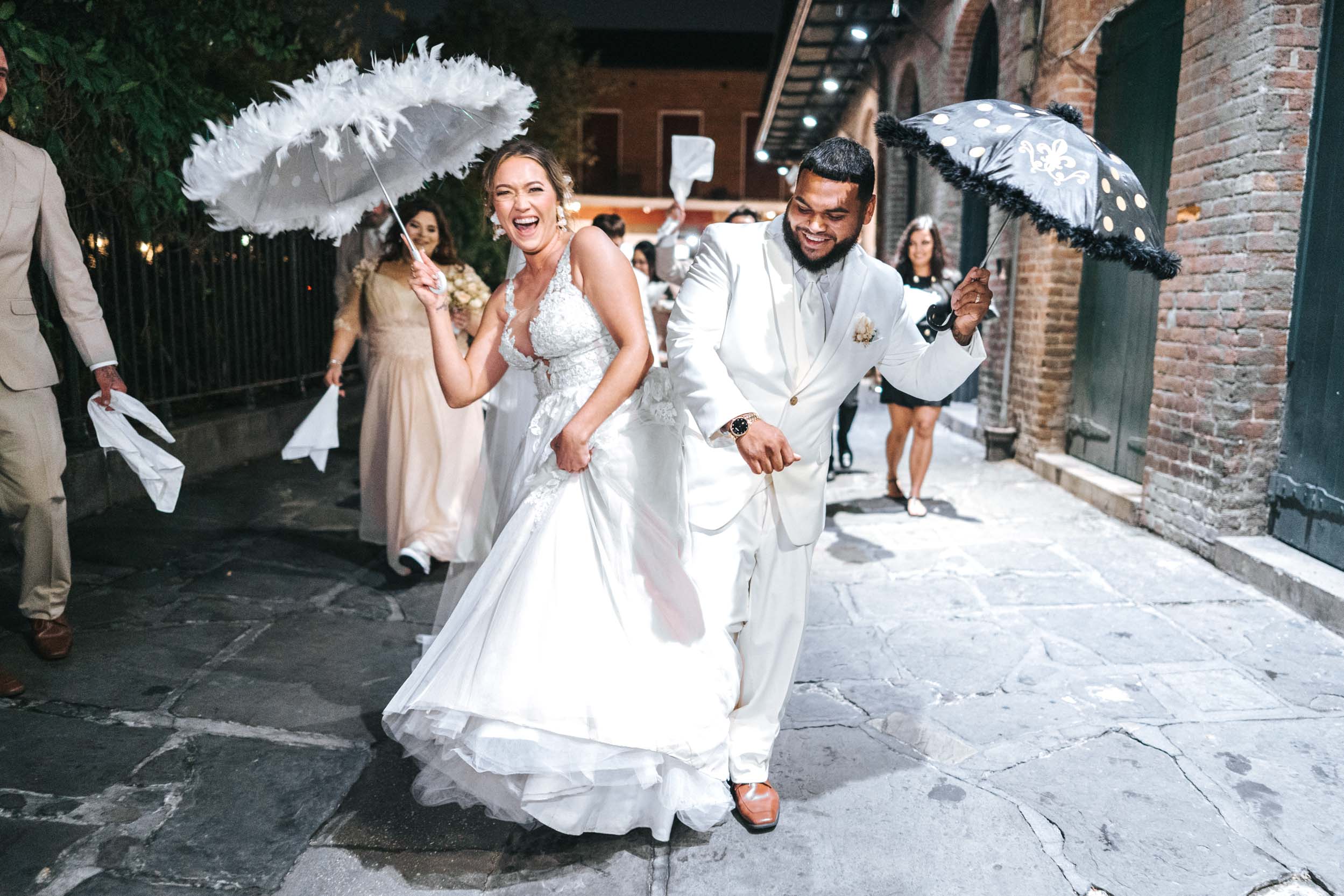 second line band parade on wedding day in French Quarter with umbrellas