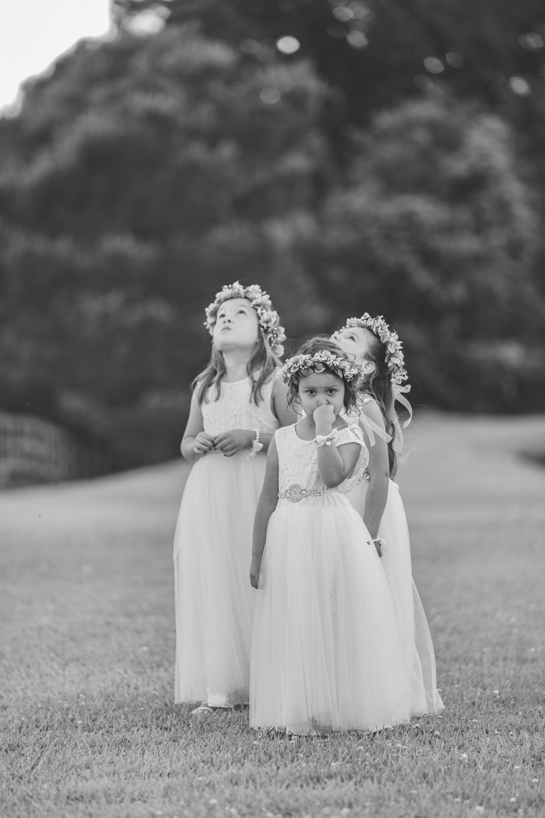 flower girls playing in a field at White Magnolia in Louisiana