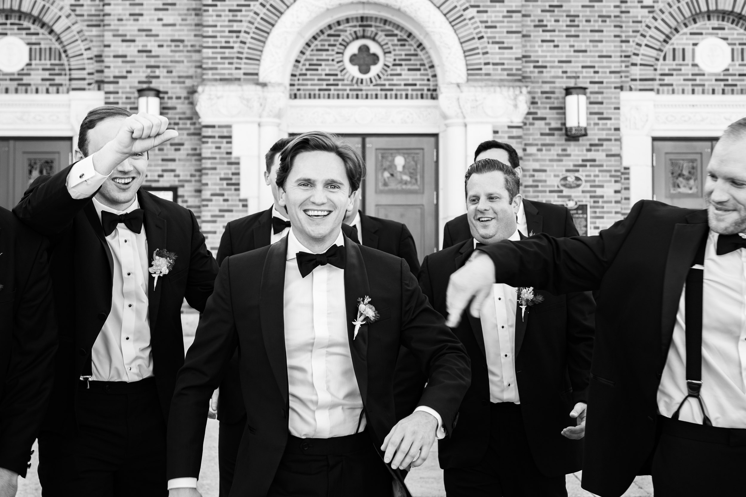 groom and groomsmen celebrating before wedding Our Lady of Lake Church in Covington