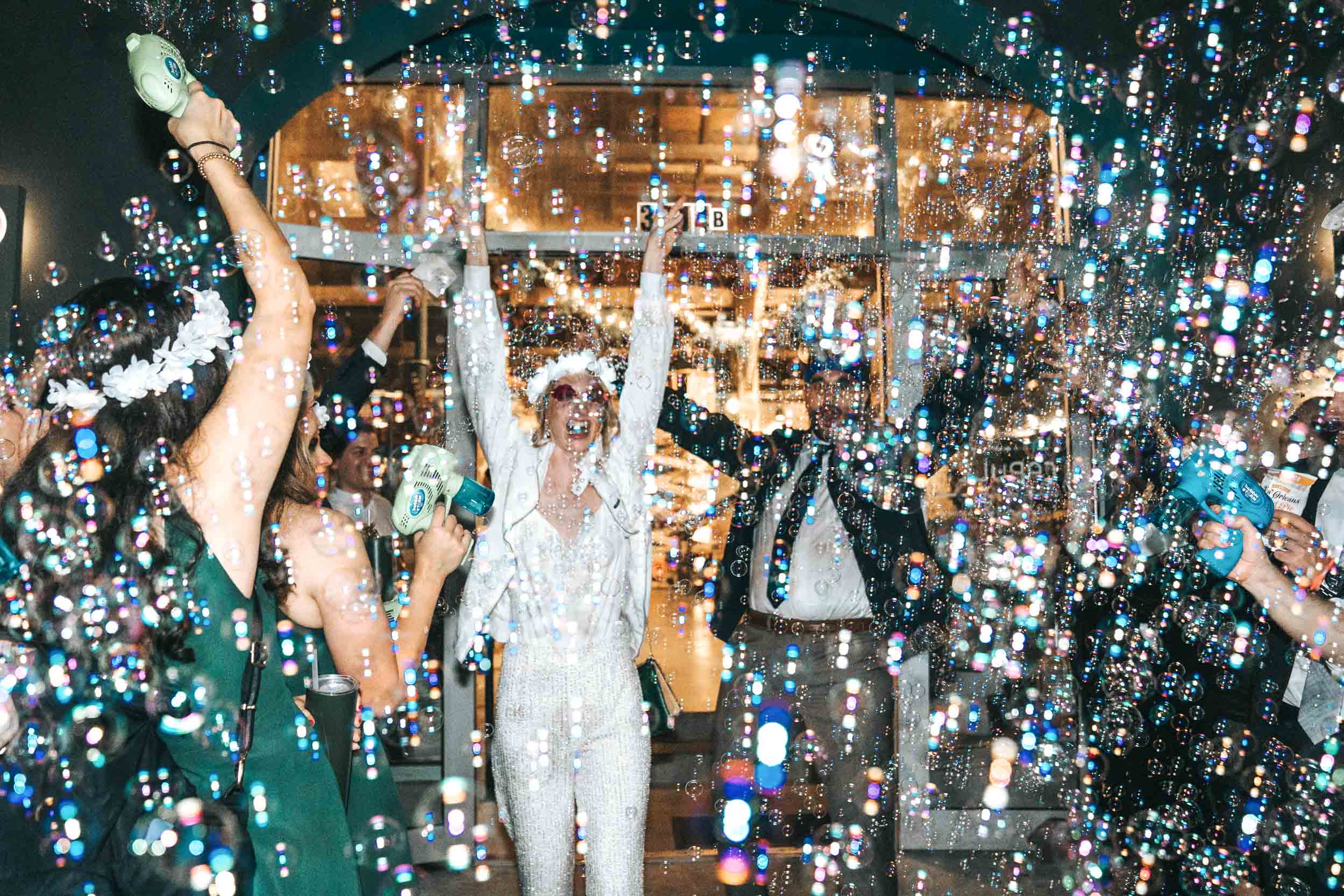 bride and groom celebrating their wedding exit with bubbles and sparklers at Capulet in New Orleans.jpg