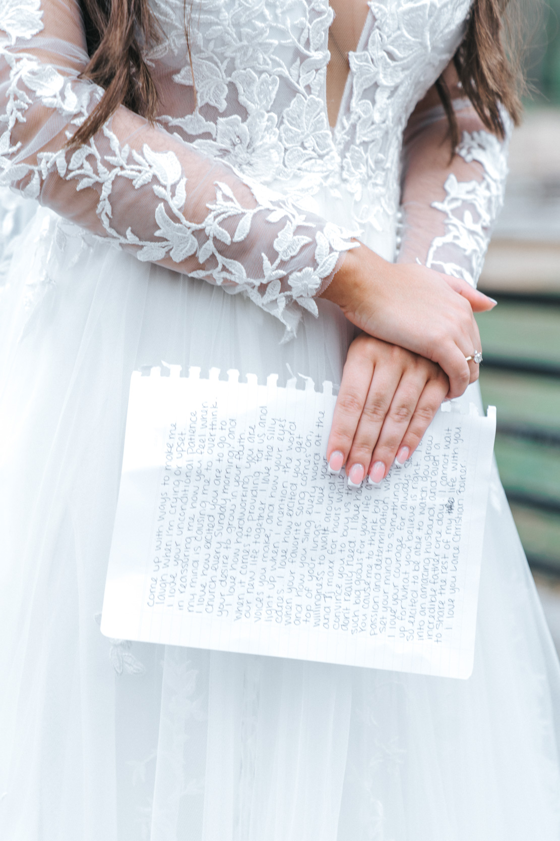bride holding her vows and letter for the groom