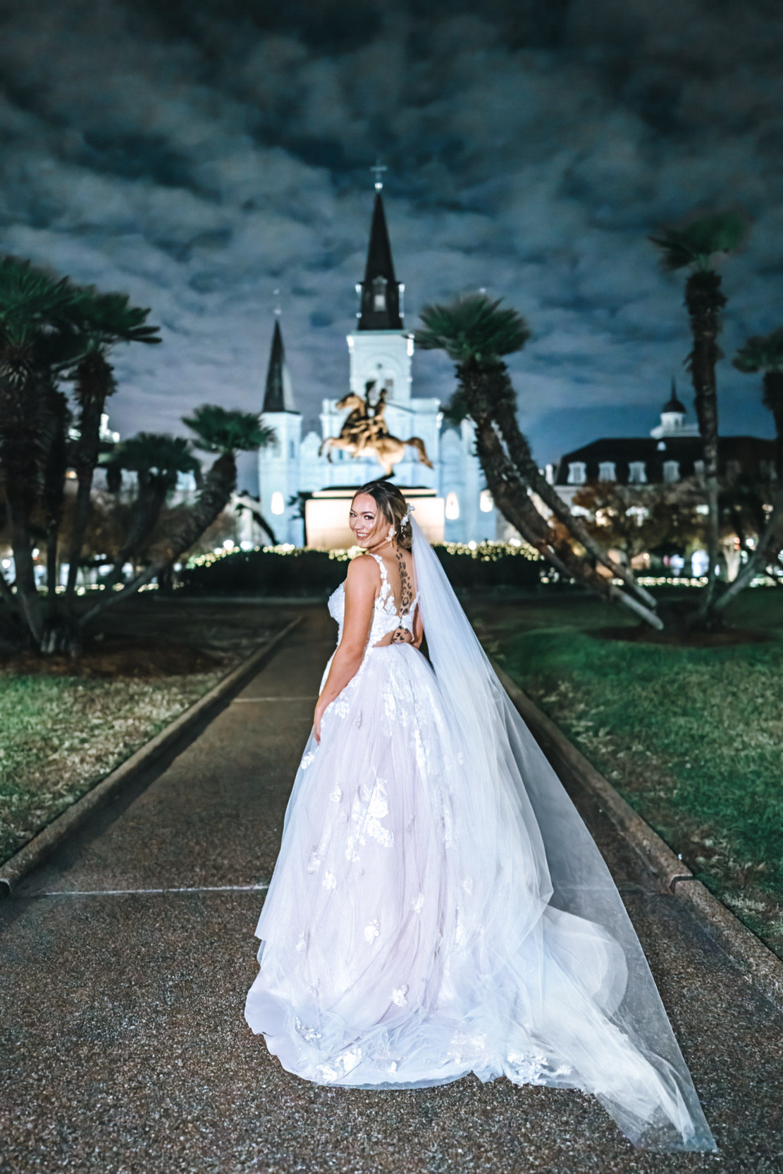 wedding bride in Jackson Square at night in front of St. Louis Cathedral