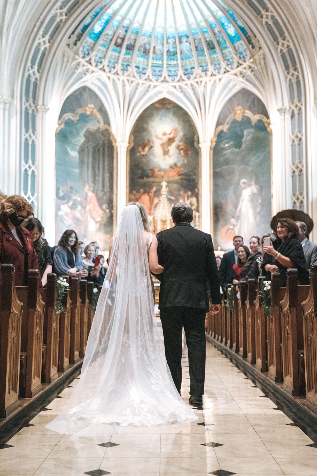 Bride and father walking up aisle of St. Patricks Church in New Orleans