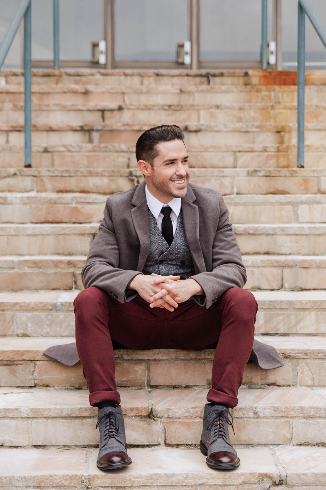 Ryan H Gray Photography smiling on stairs in Louis Armstrong Park before shooting a wedding