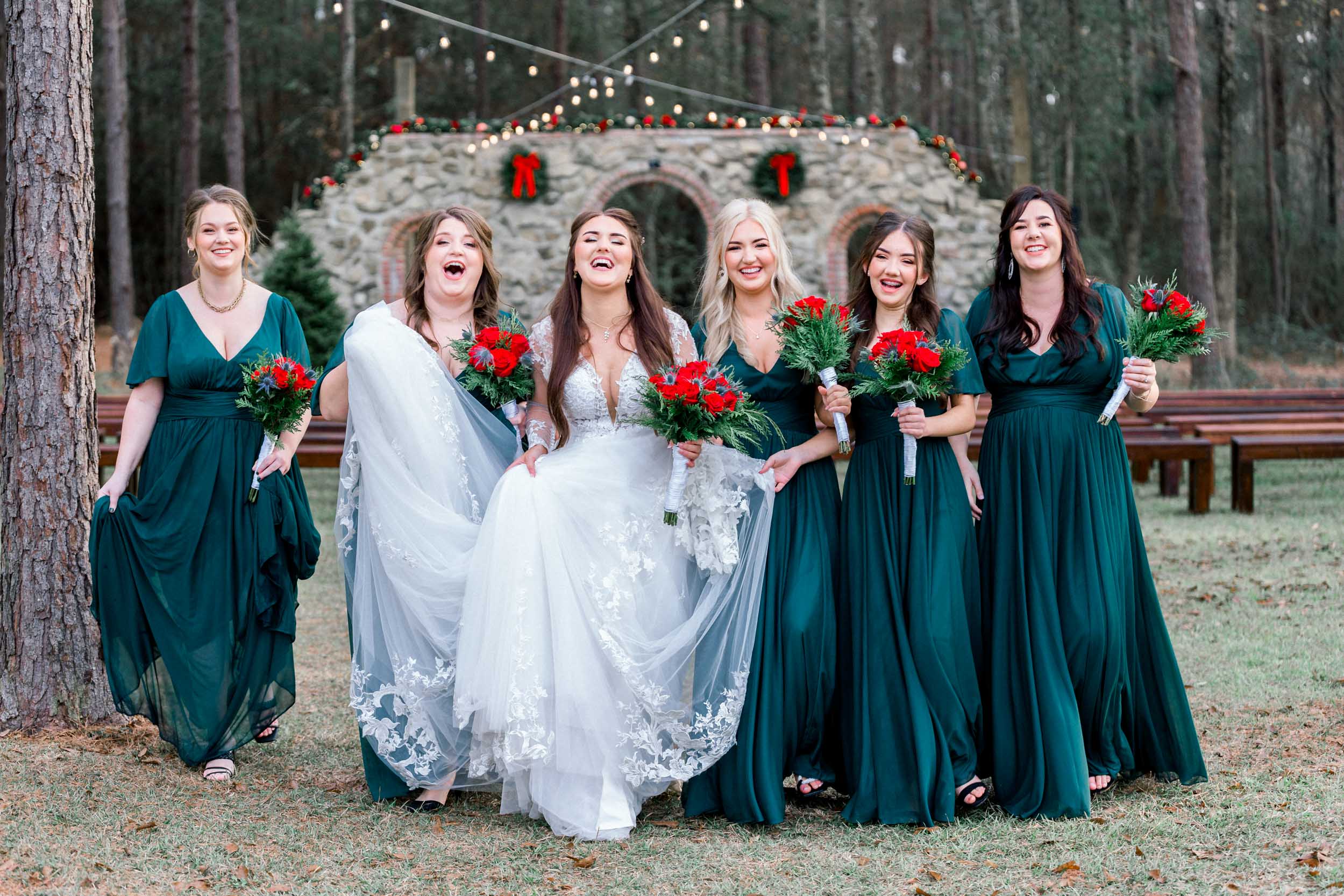 Bride and bridemaids laughing together at Creekview Barn in Mississippi
