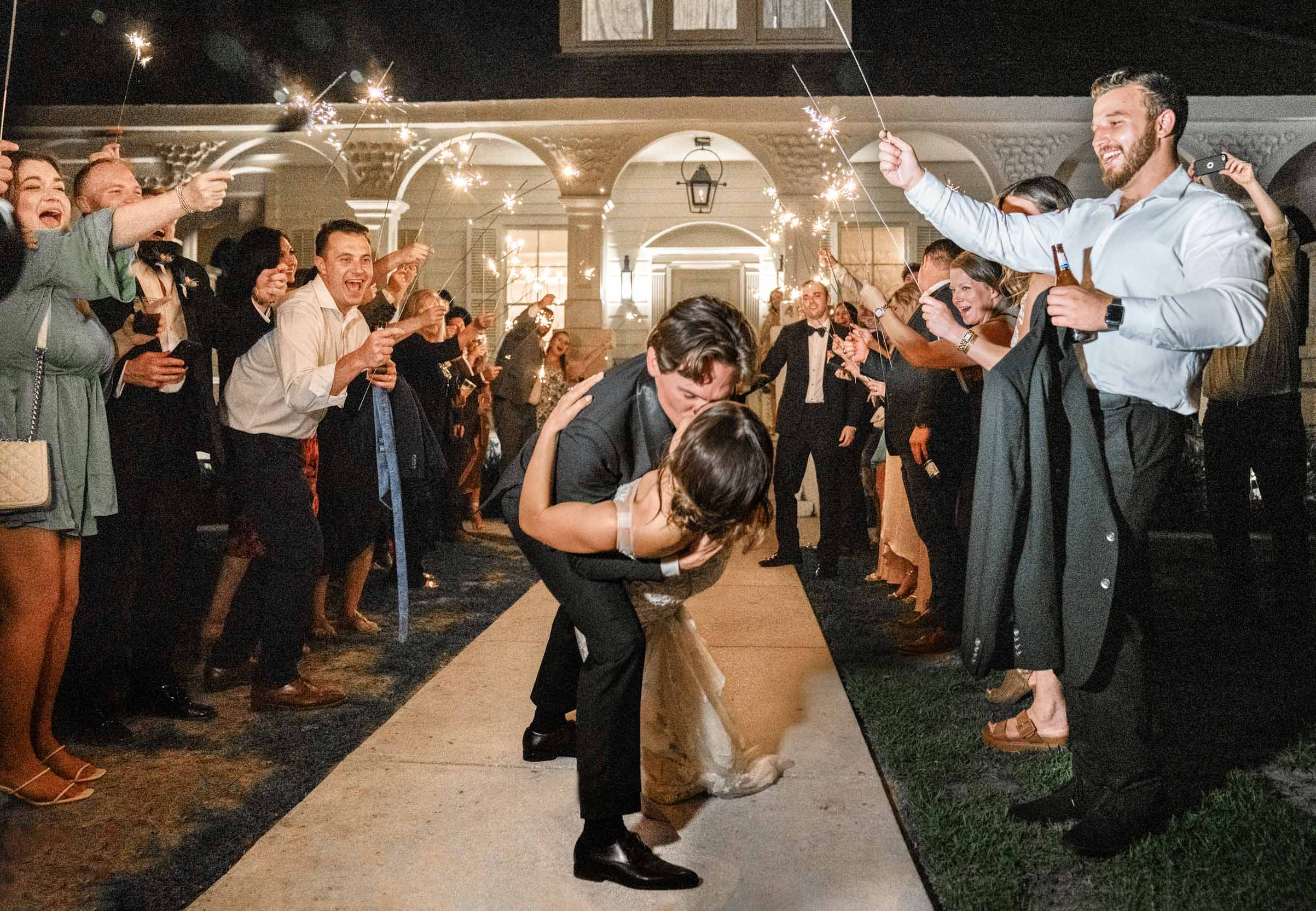 Groom dipping bride and kissing her during celebration exit at Maison Lafitte in Covington, Louisiana