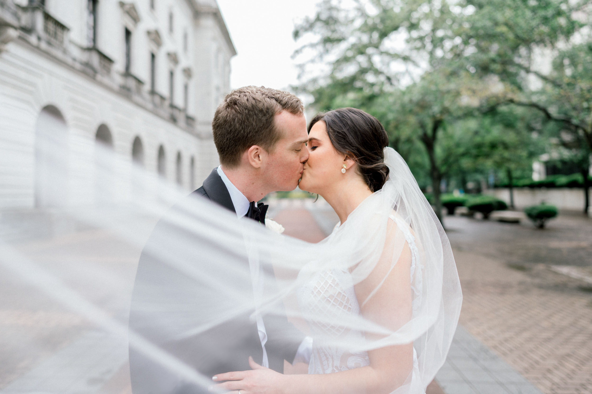 Bride and groom kissing at Lafayette Square in New Orleans