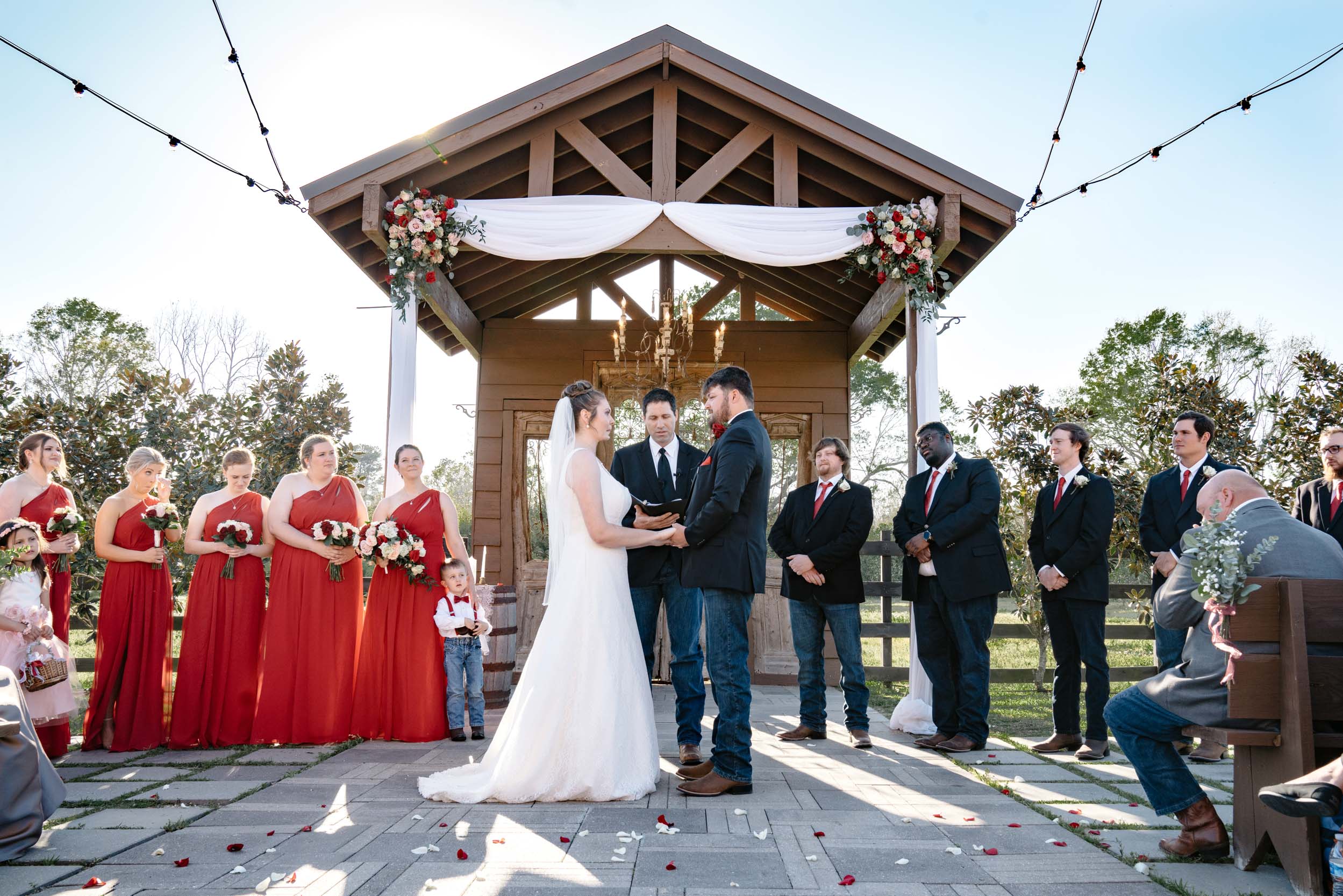 wedding ceremony under an arbor of flowers at Berry Barn in Amite, Lousiana