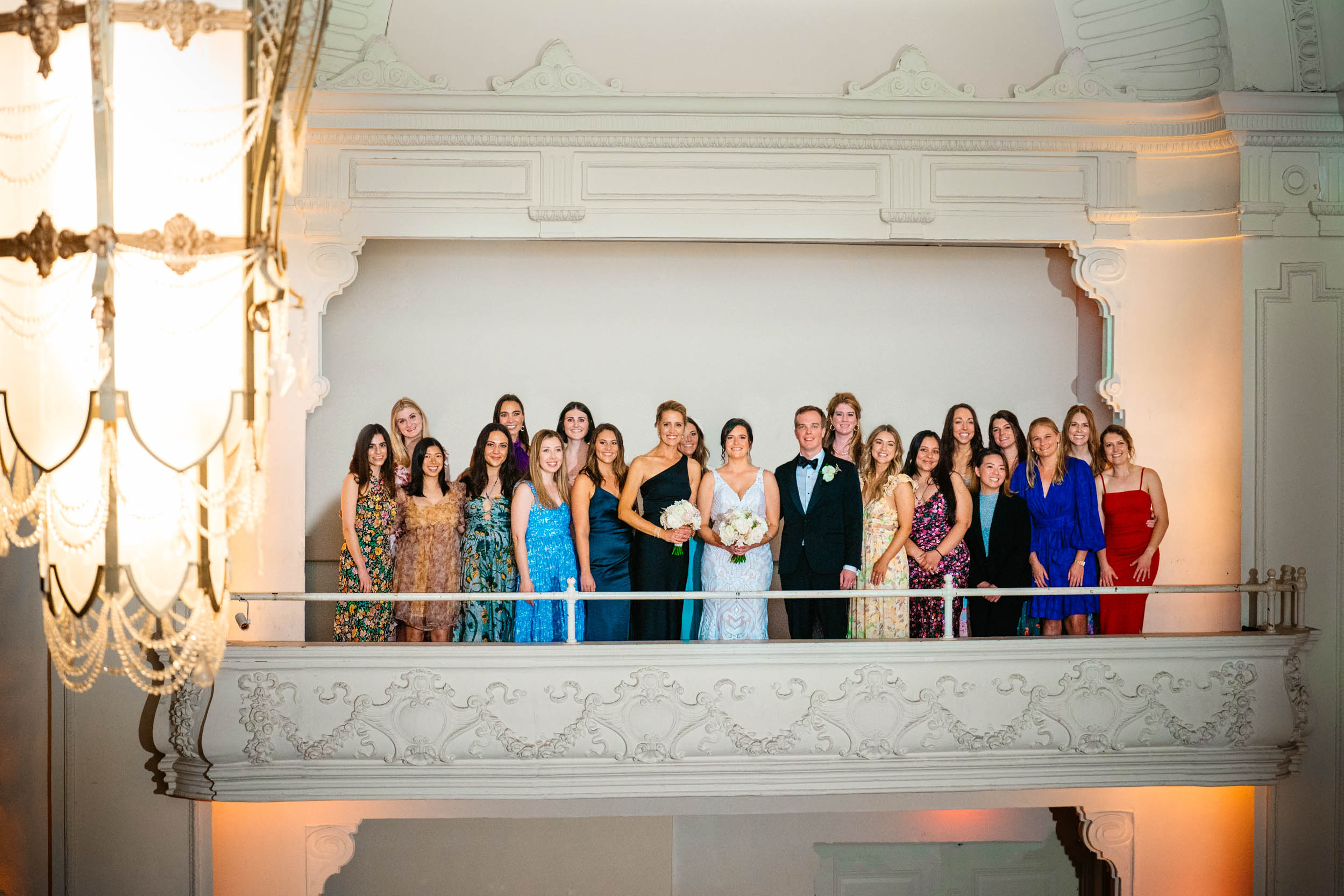 Bride and bridesmaids on balcony at Civic Theater in New Orleans