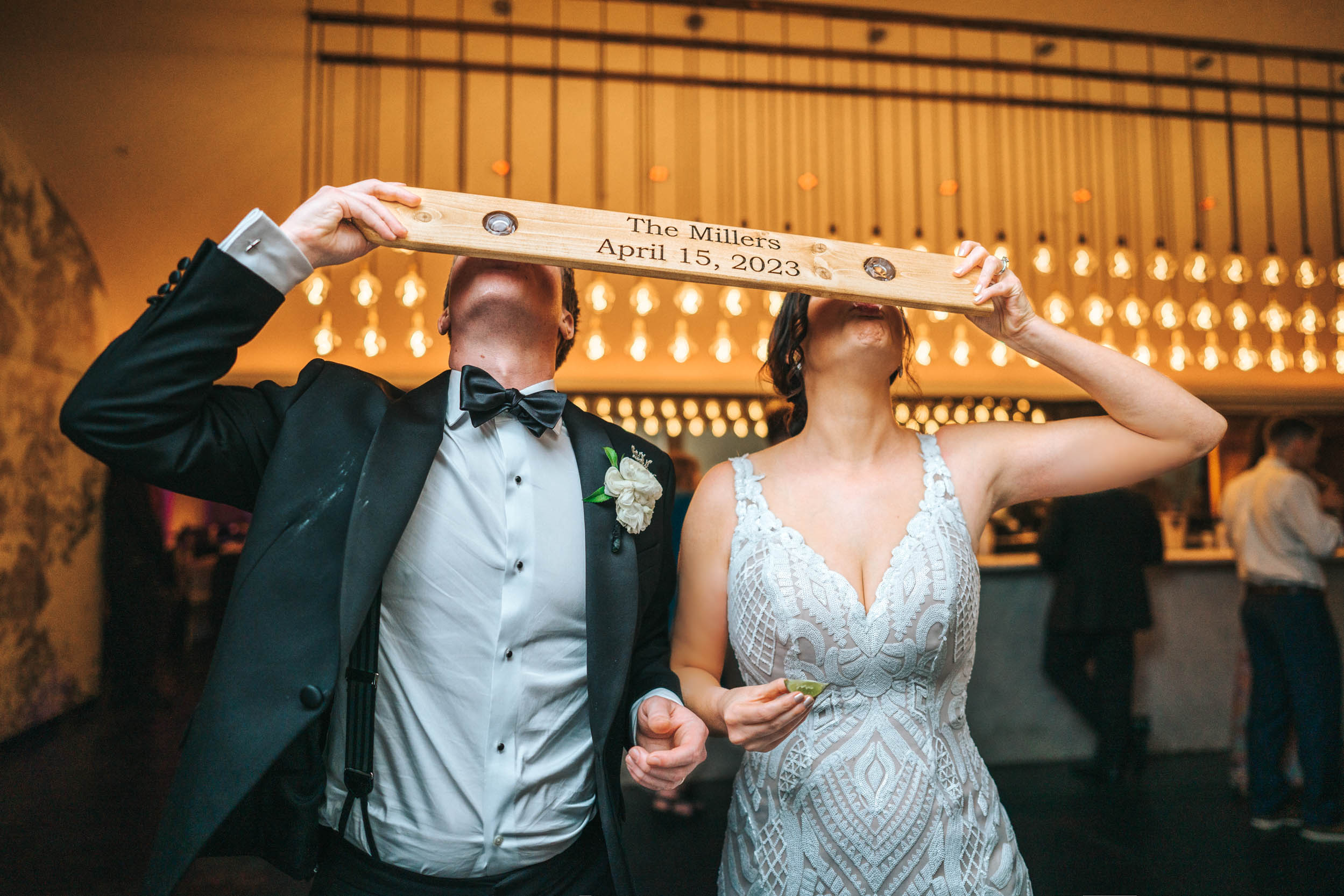 Bride and groom having a shot and shotski at Civic Theater in New Orleans