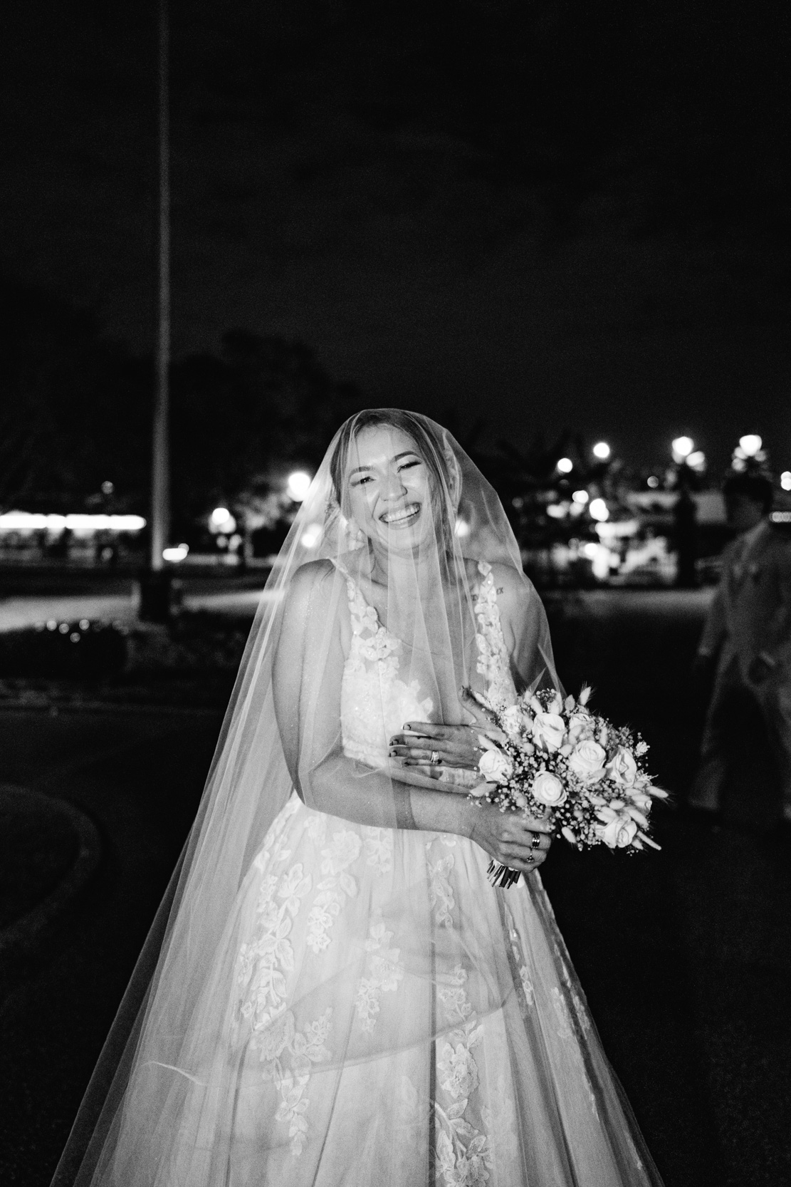Happy bride with flowers and veil in Jackson Square New Orleans