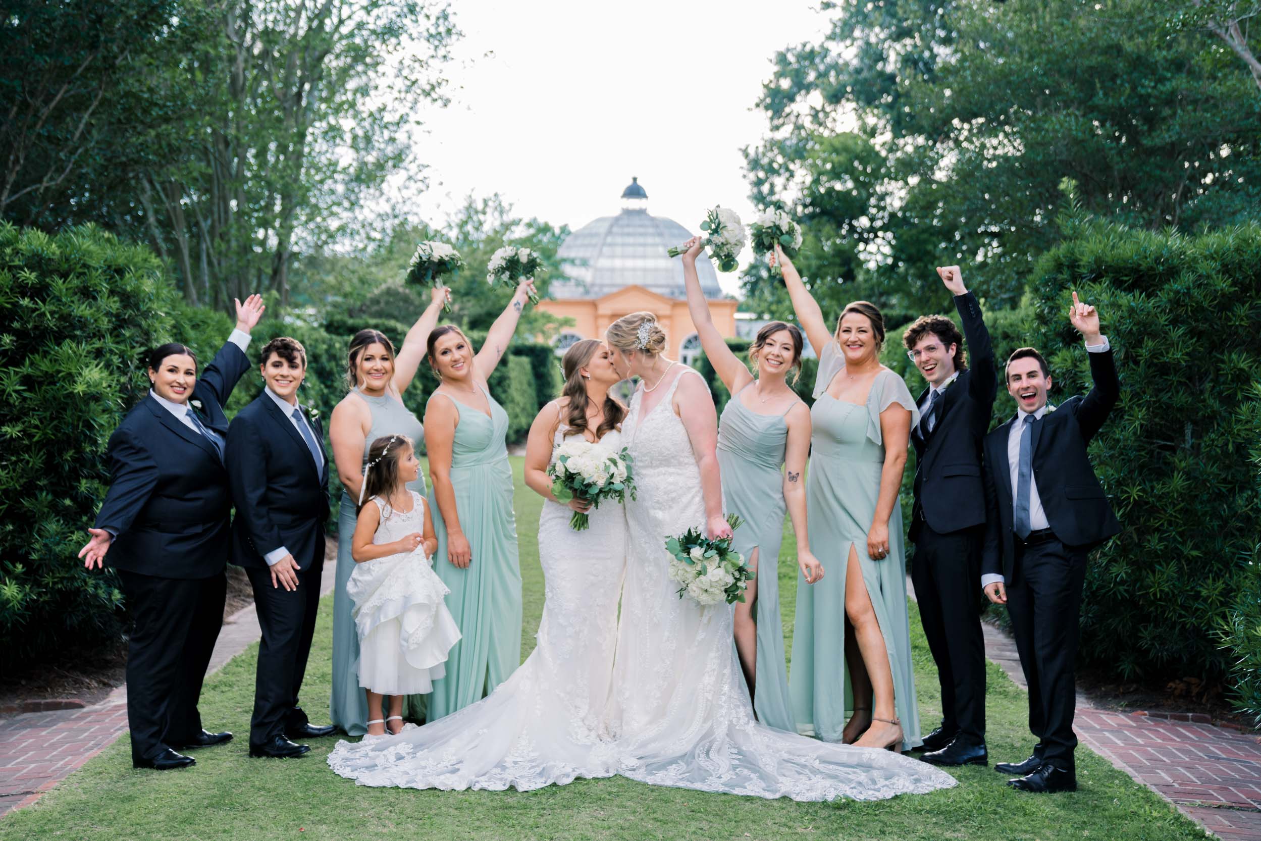 Brides and wedding party celebrating in City Park Botanical Gardens